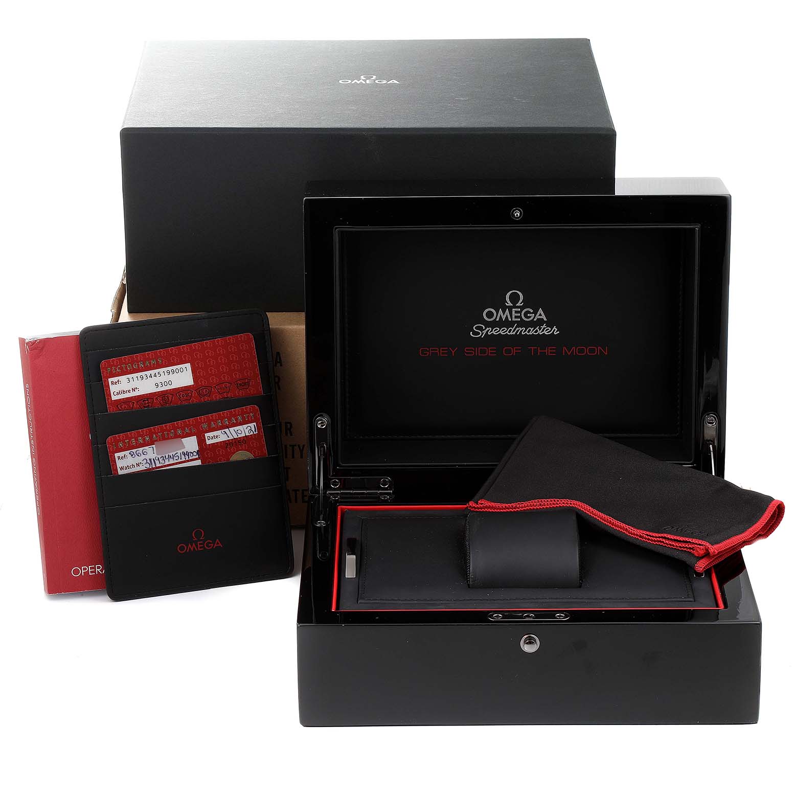 The image shows the packaging and accessories for the Omega Speedmaster 311.93.44.51.99.001 Men's Ceramic Silver Dial 311.93.44.51.99.001 Men's Ceramic Silver Dial "Grey Side of the Moon" watch, including the box, manuals, and documentation.