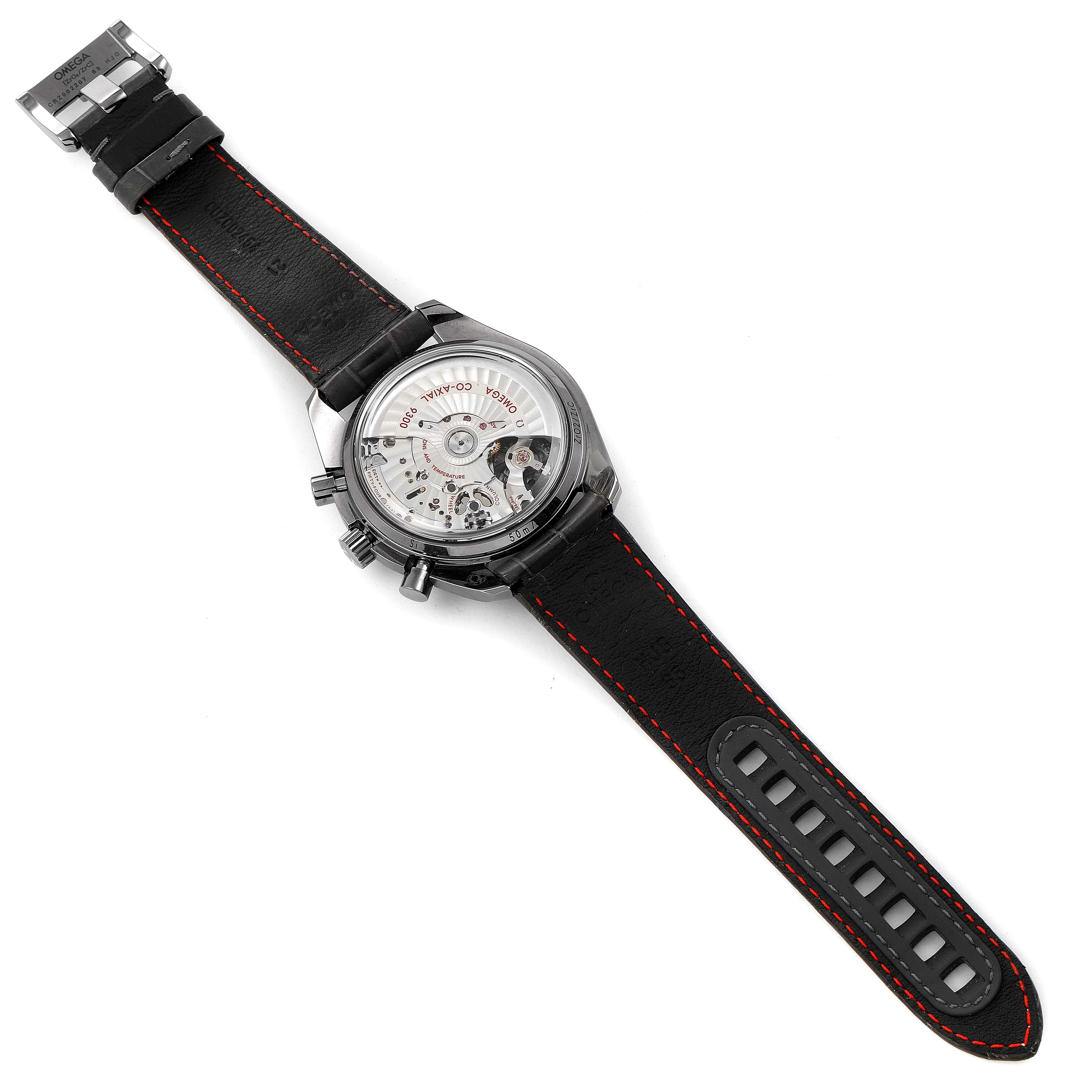 The Omega Speedmaster 311.93.44.51.99.001 Men's Ceramic Silver Dial 311.93.44.51.99.001 Men's Ceramic Silver Dial watch is shown from the back, revealing its intricate movement and black strap with red stitching.