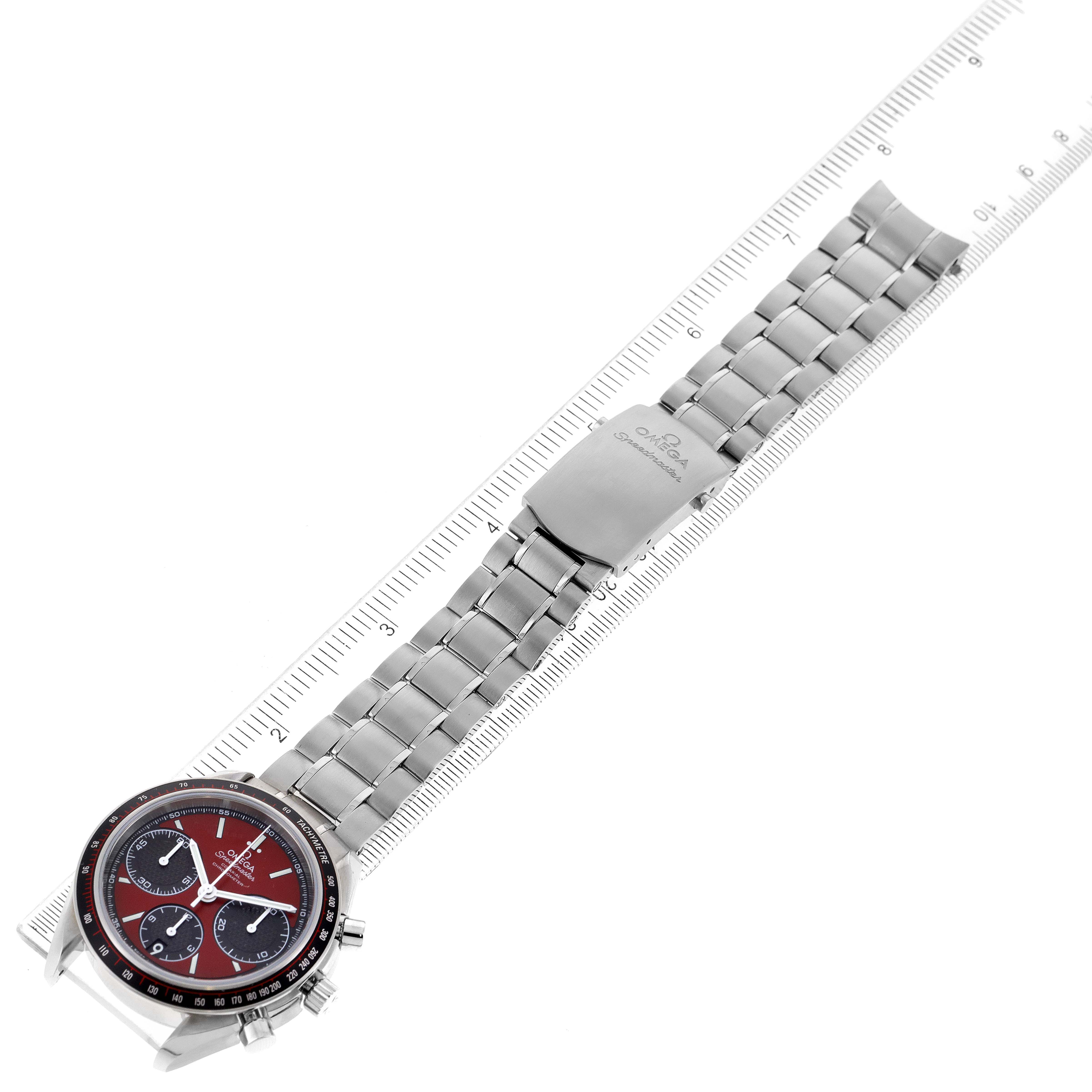 The Omega Speedmaster 326.30.40.50.11.001 Men's Stainless Steel Red Dial 326.30.40.50.11.001 Men's Stainless Steel Red Dial watch is shown from a top-down angle, displaying its round face, metal bracelet, and clasp.