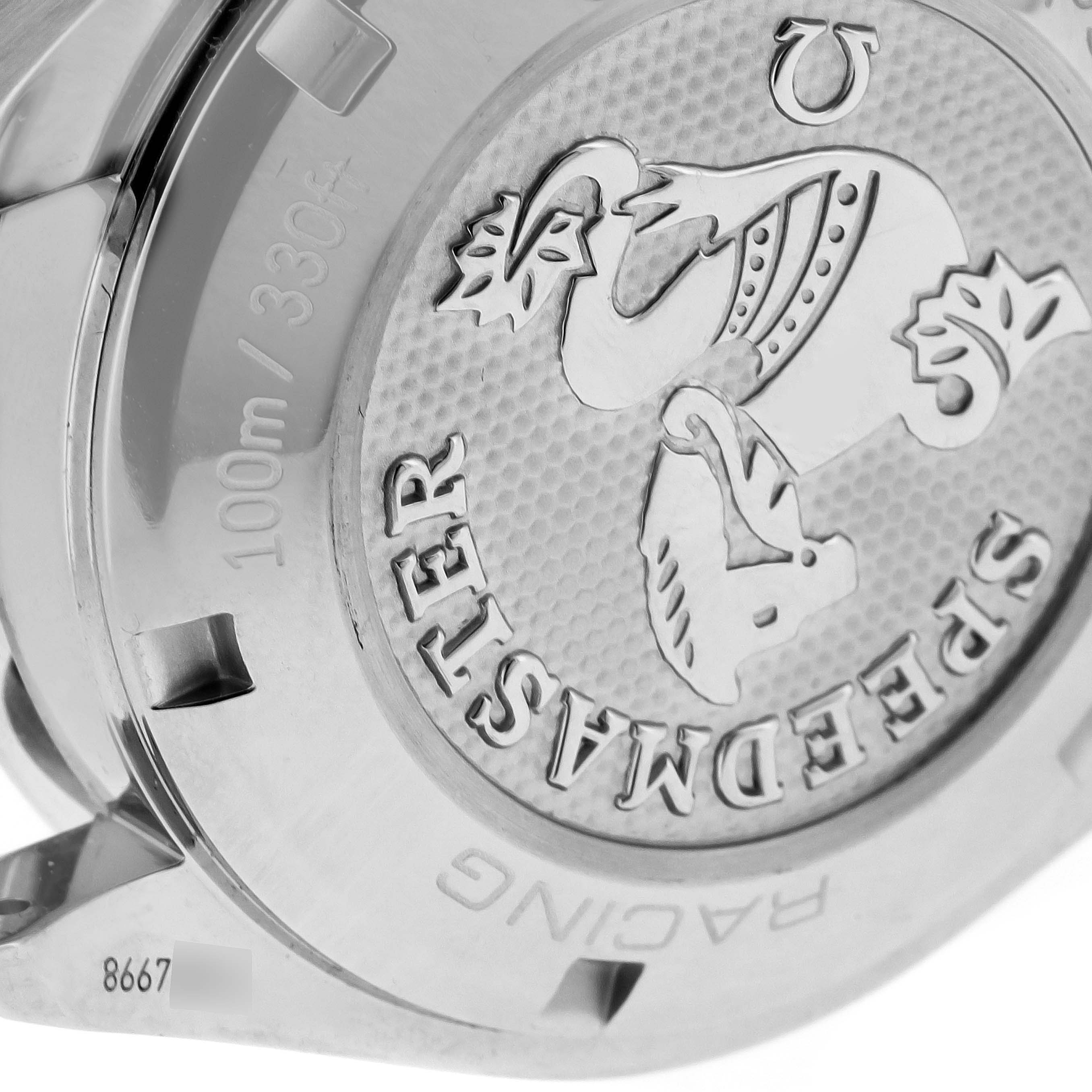 This image shows the back case of an Omega Speedmaster 326.30.40.50.11.001 Men's Stainless Steel Red Dial 326.30.40.50.11.001 Men's Stainless Steel Red Dial watch, highlighting the etched design and text.