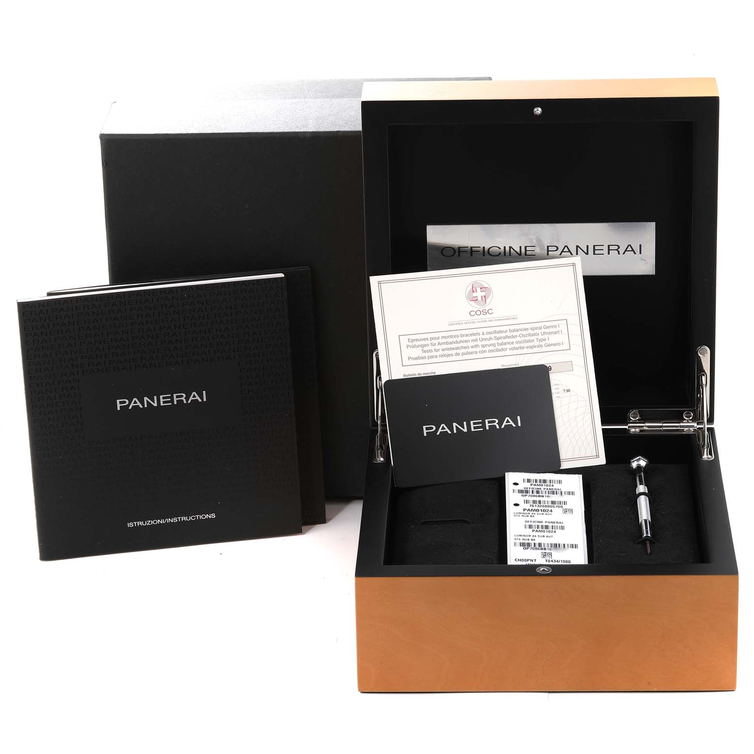 The image shows the packaging and accessories of a Panerai Submersible PAM01024 Men
s Stainless Steel Black Dial PAM01024 Men
s Stainless Steel Black Dial watch, including the box, manuals, warranty cards, and a tool.