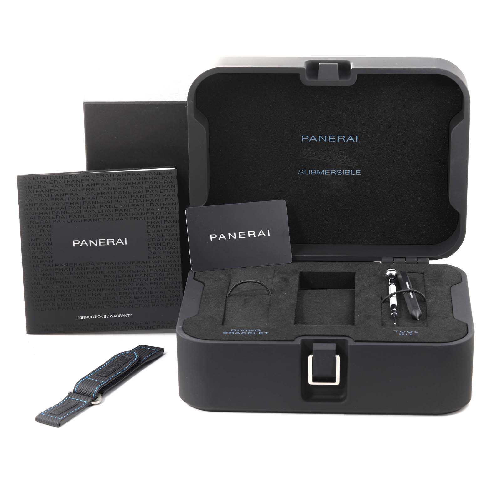 The image shows the packaging and accessories of a Panerai Submersible PAM00973 Men's Titanium Black Dial PAM00973 Men's Titanium Black Dial watch, including manuals, a tool kit, a strap, and the storage case.