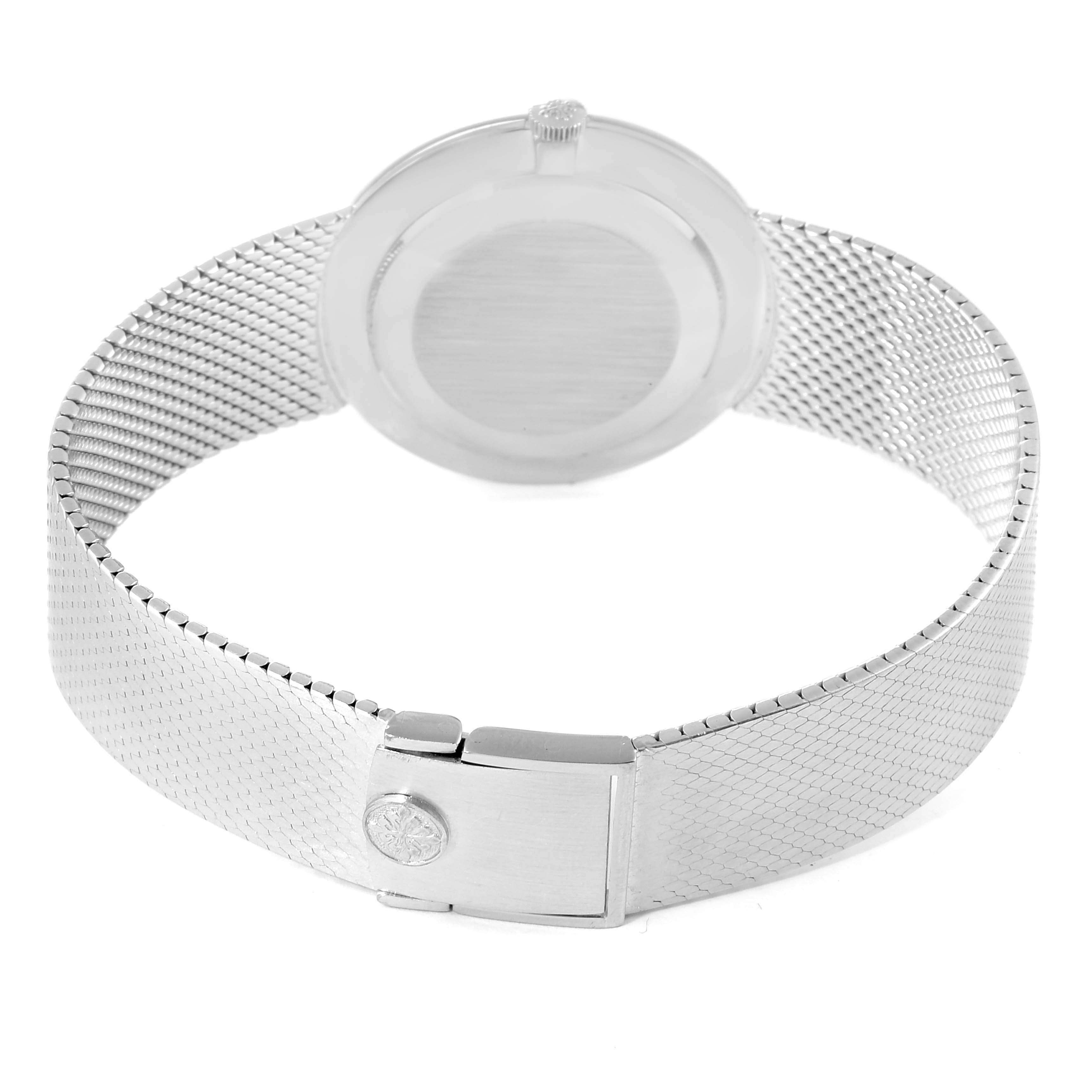 This image shows the backside and clasp of a Vintage Patek Philippe watch, highlighting its mesh bracelet and crown.