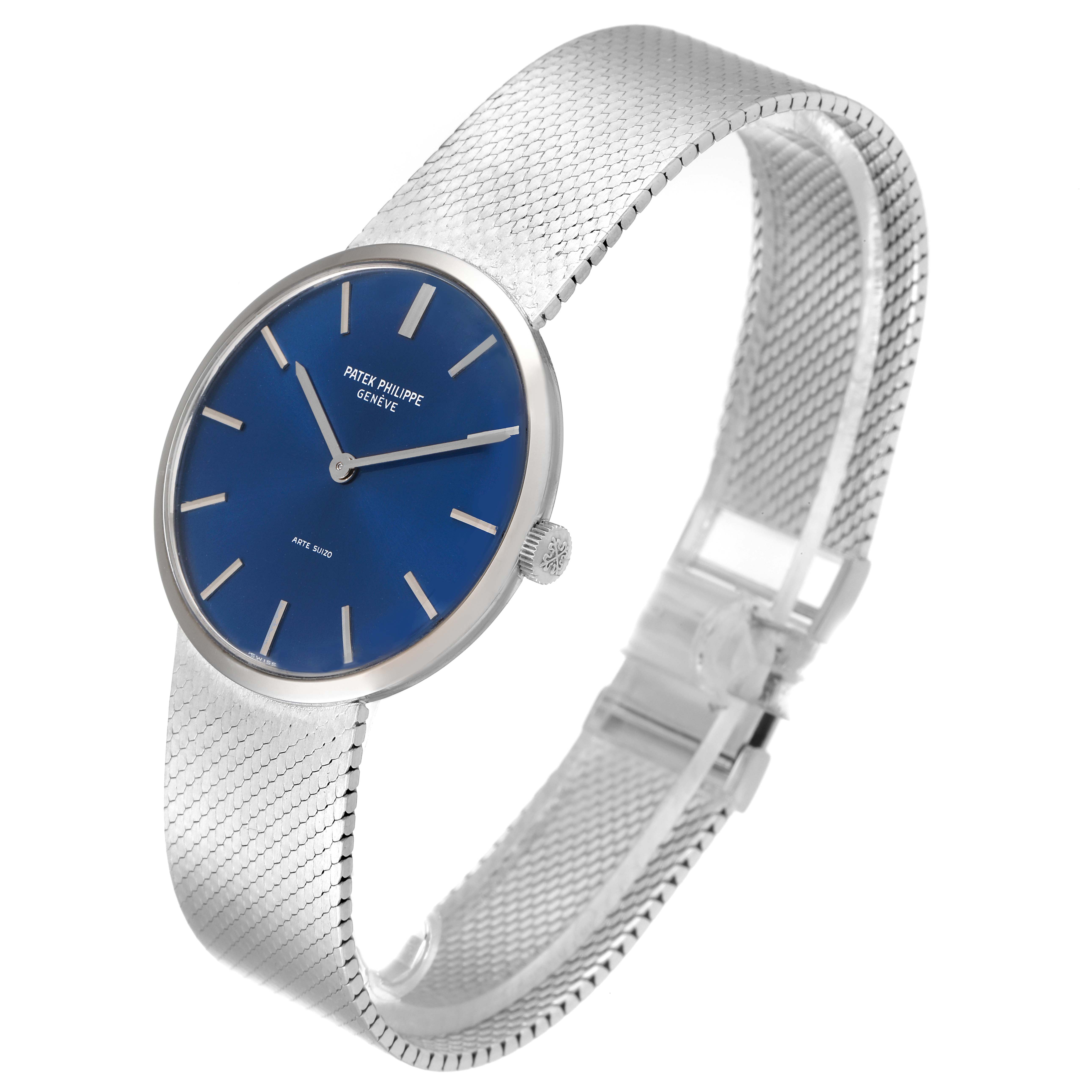 The image shows a Patek Philippe Vintage model watch at an angled side view, highlighting its blue dial and metal mesh strap.