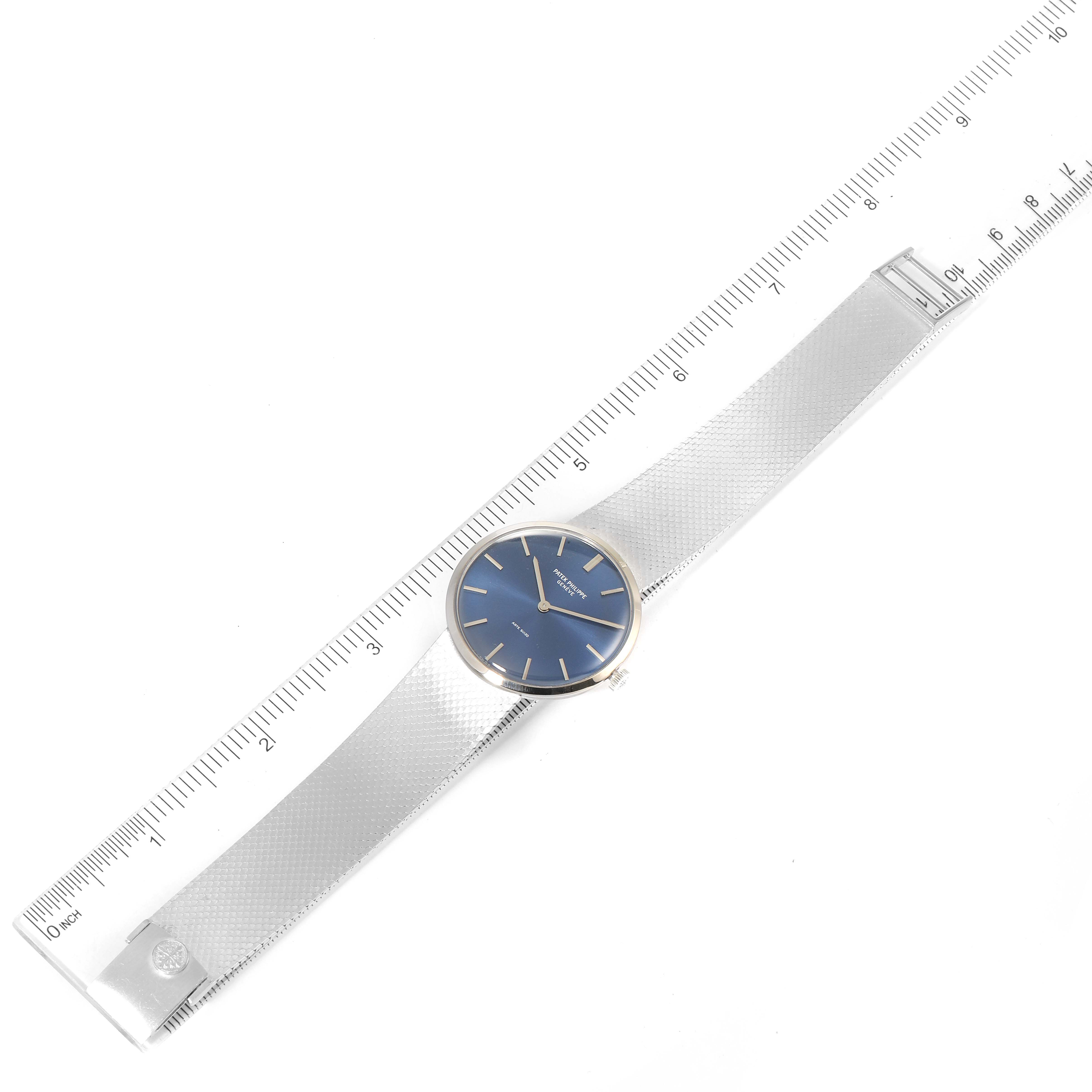This image shows a top view of a Vintage Patek Philippe watch with a blue dial and metallic mesh strap, alongside a ruler.