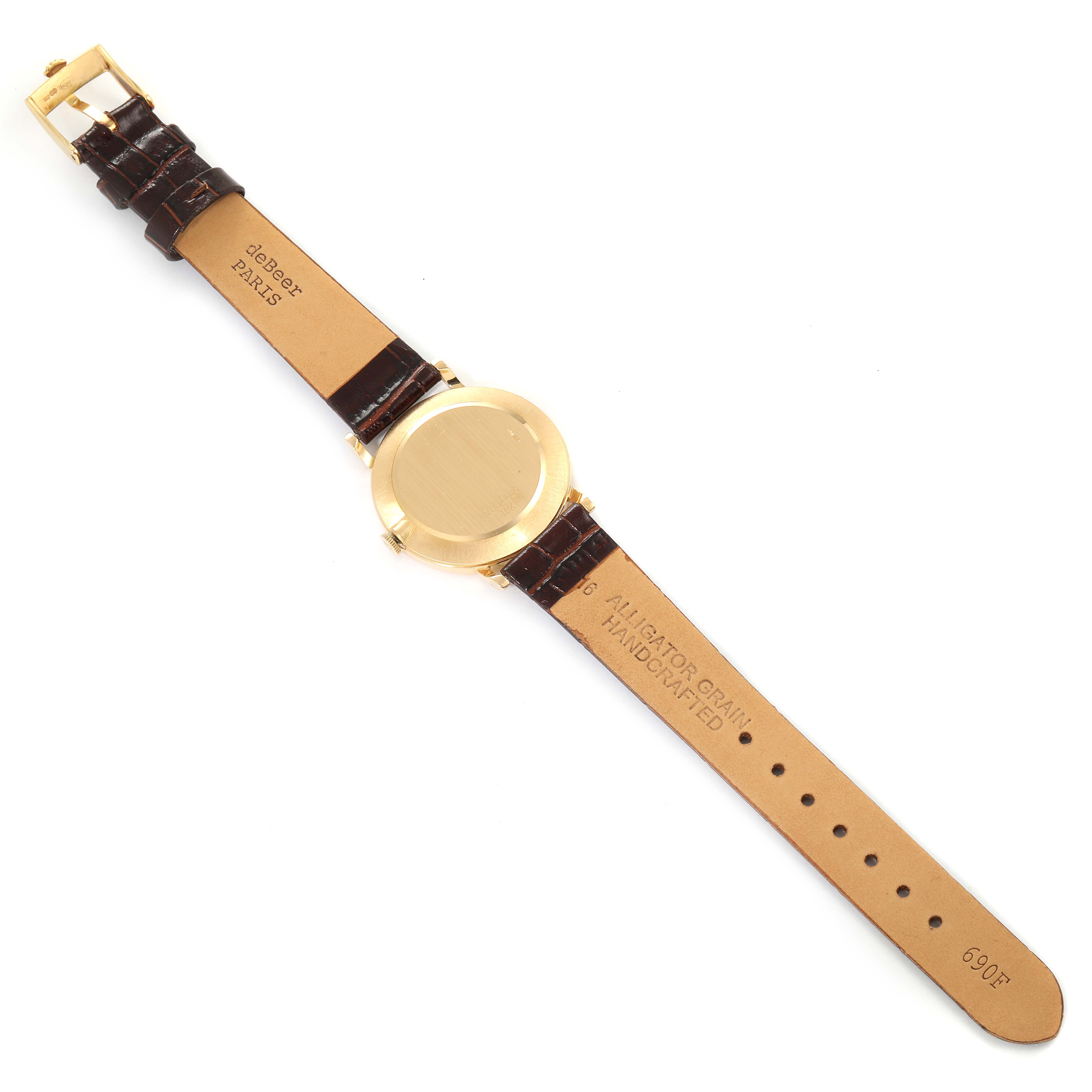 This image shows the back of a Rolex Cellini 5112 Men's Yellow Gold Champagne Dial 5112 Men's Yellow Gold Champagne Dial watch laid flat, showcasing its gold case and brown alligator grain leather strap.