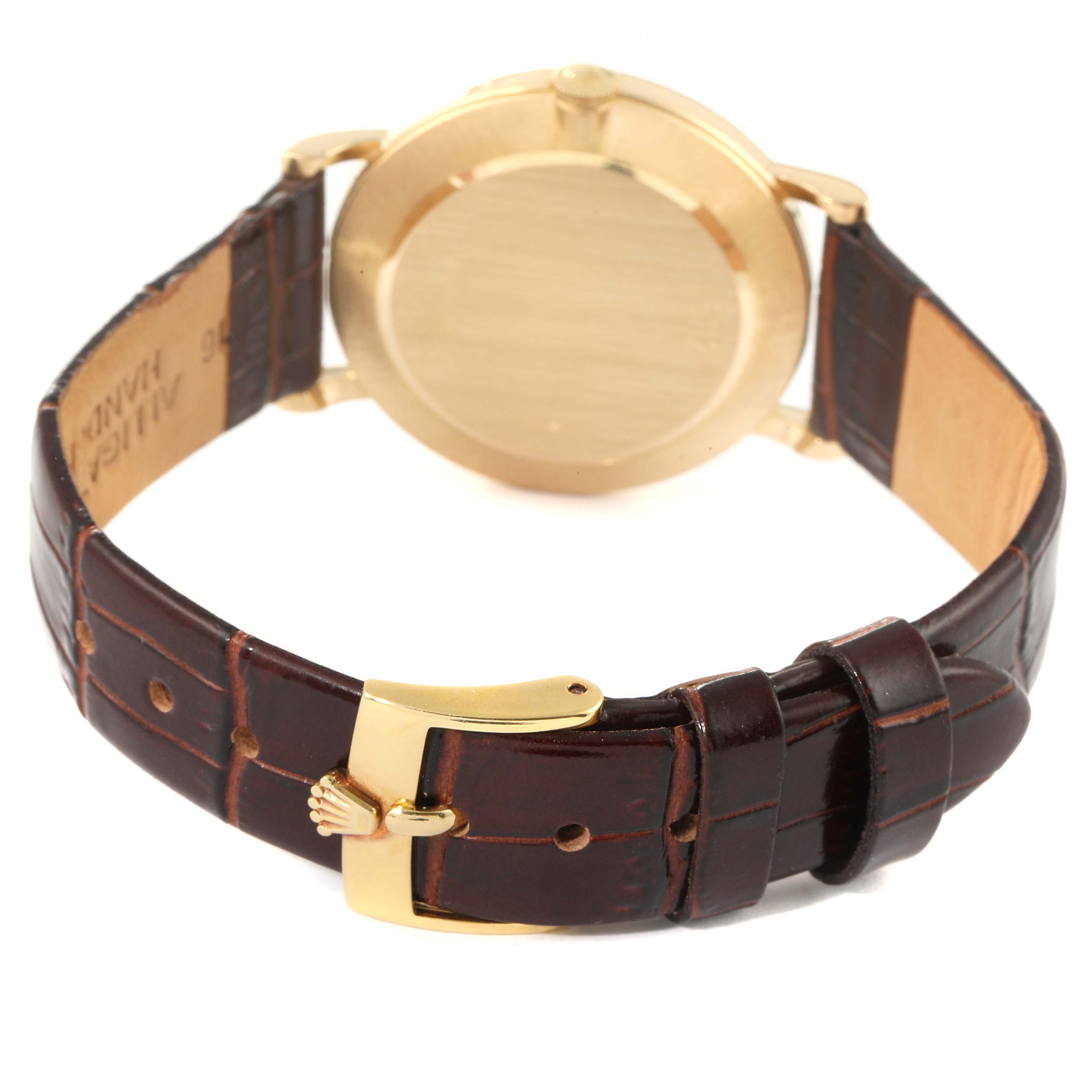 The image shows the back of a Rolex Cellini 5112 Men's Yellow Gold Champagne Dial 5112 Men's Yellow Gold Champagne Dial watch, focusing on the case back and brown leather strap with a gold buckle.