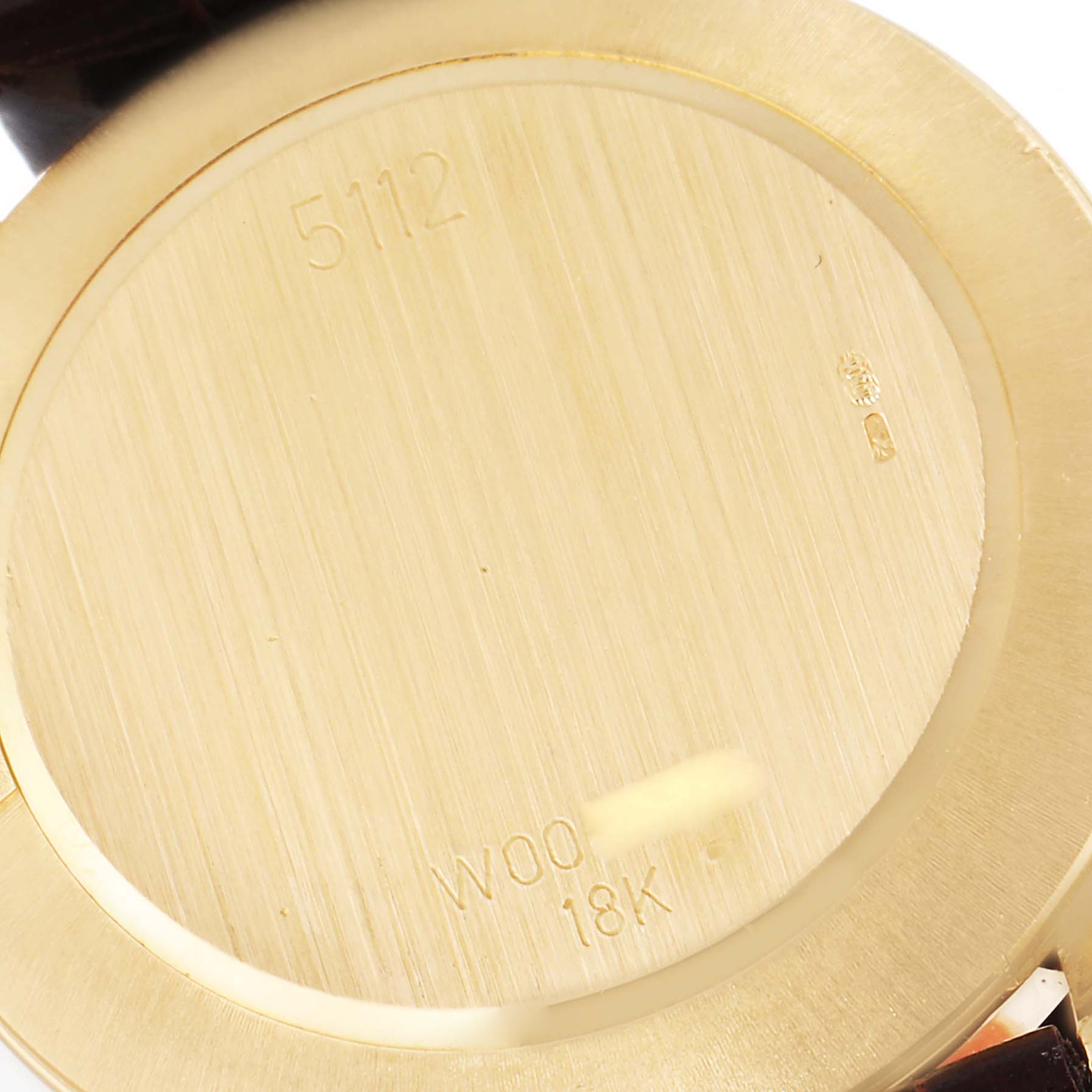 This image shows the back of a Rolex Cellini 5112 Men's Yellow Gold Champagne Dial 5112 Men's Yellow Gold Champagne Dial watch, highlighting the 18K gold markings and model number 5112.