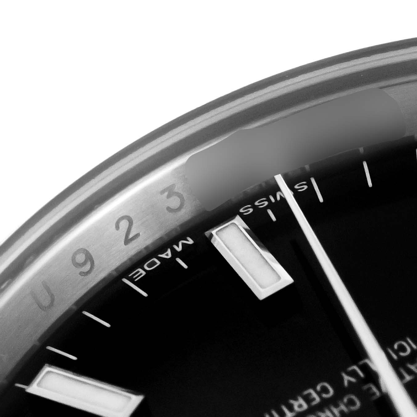 The image shows a close-up of the dial and part of the bezel of a Rolex Date 115200 Men's Stainless Steel Black Dial 115200 Men's Stainless Steel Black Dial model watch.