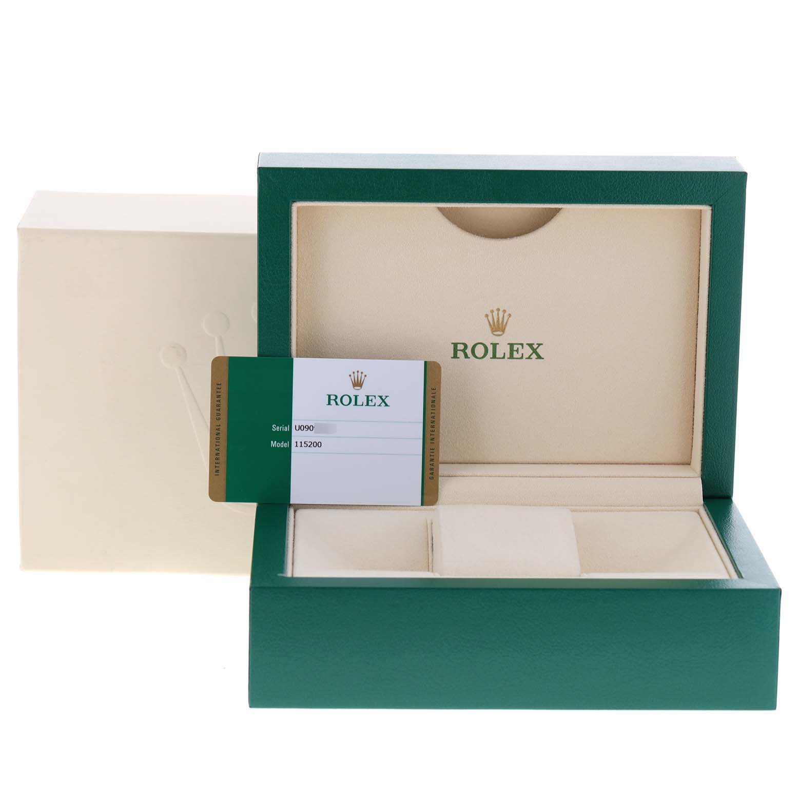 The image shows an open Rolex Date 115200 Men's Stainless Steel Black Dial 115200 Men's Stainless Steel Black Dial model watch box with a certification card on display.