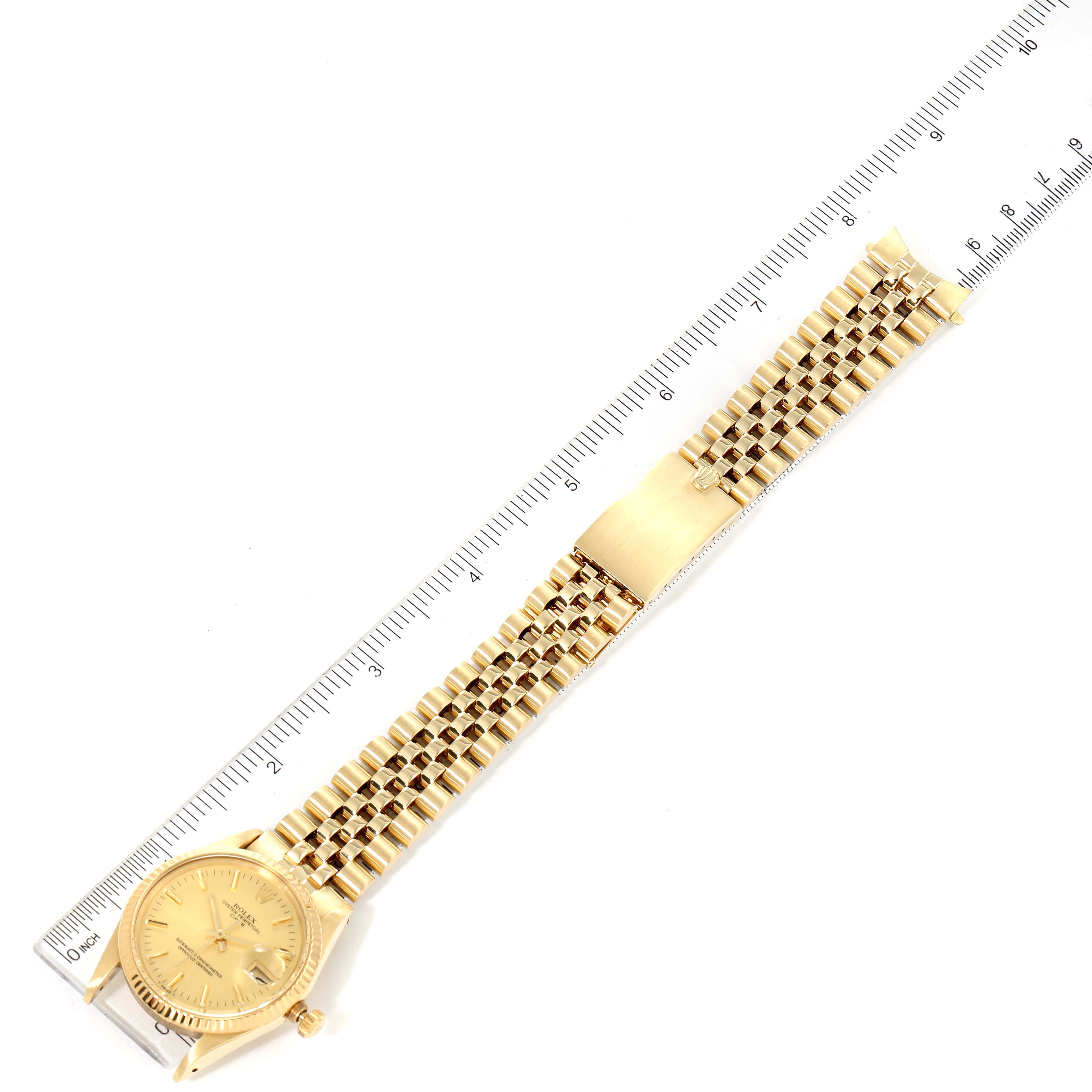The image shows a full top view of a Rolex Vintage Collection 15007 Men's Yellow Gold Champagne Dial 15007 Men's Yellow Gold Champagne Dial watch, including the face, bracelet, and clasp, alongside a ruler for scale.