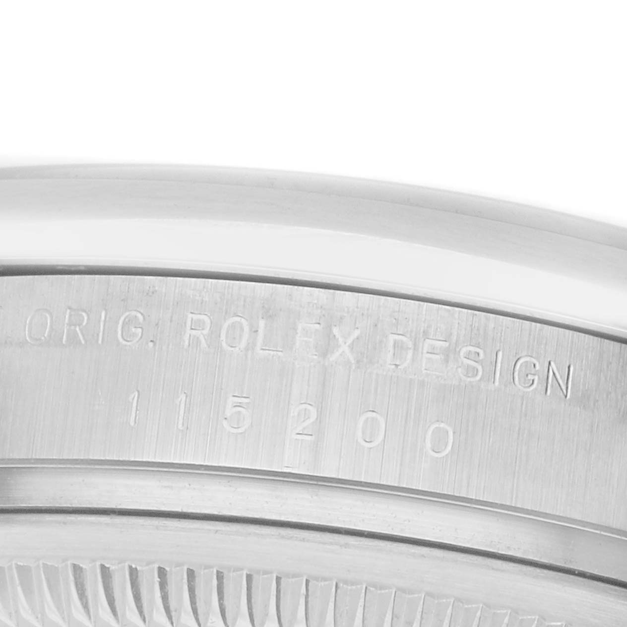 The image shows the side of a Rolex Date 115200 Men's Stainless Steel Pink Dial watch case with engraved model information.