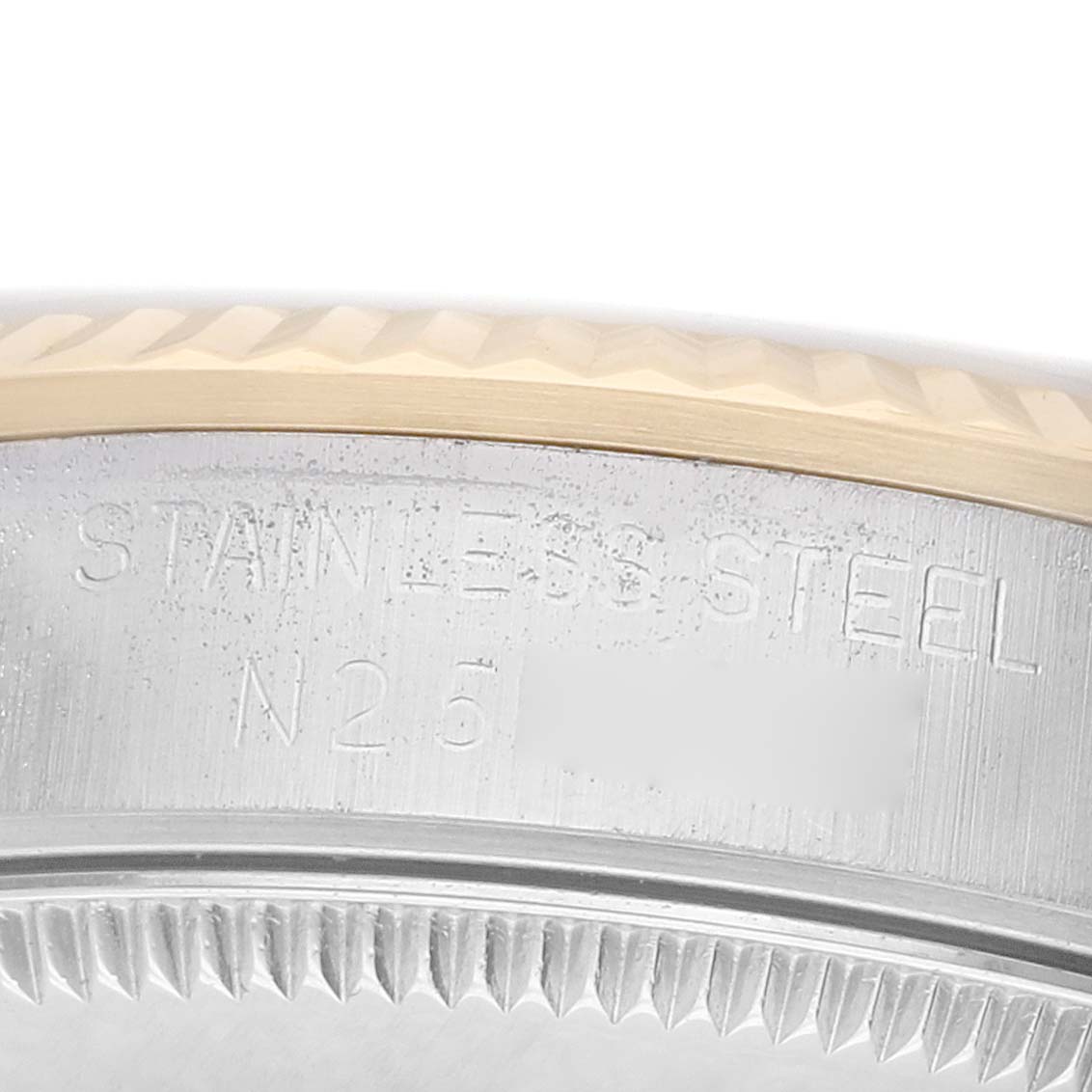The image shows a close-up of the bezel and side, featuring the fluted edge and "STAINLESS STEEL" engraving of a Rolex Datejust 68273 Women's Steel and Gold (two tone) Champagne Dial.