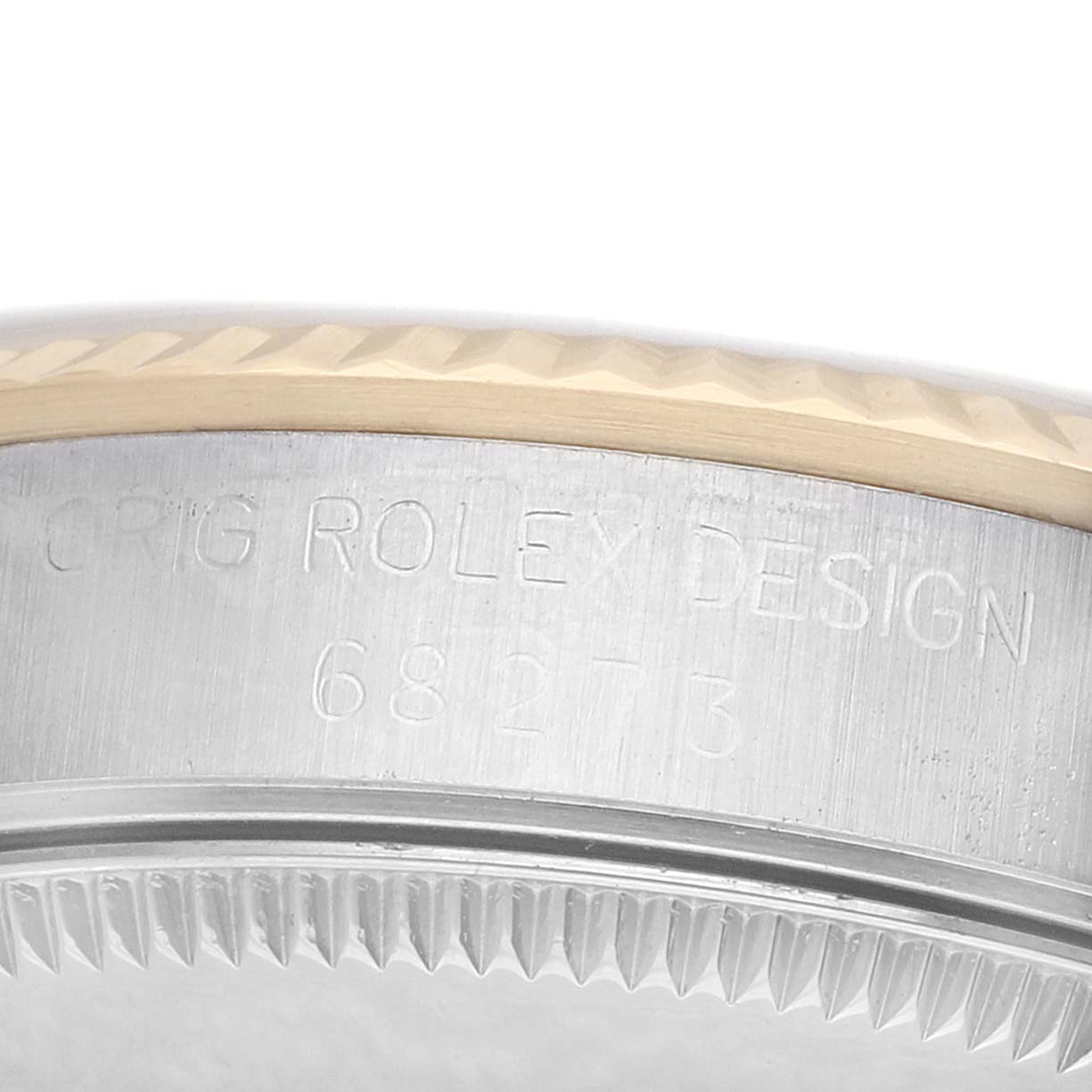 The image shows a close-up of the Rolex Datejust 68273 Women's Steel and Gold (two tone) Champagne Dial's fluted bezel and engraved case edge.