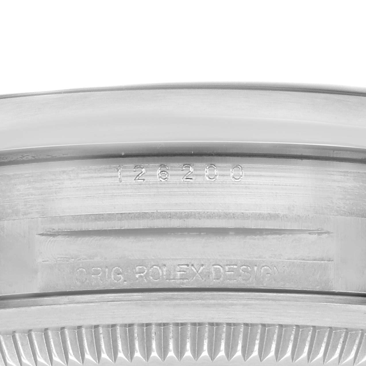 The image shows a close-up of the inner rim and serial number engraving on a Rolex Datejust 126200 Men's Stainless Steel Black Dial 126200 Men's Stainless Steel Black Dial watch.