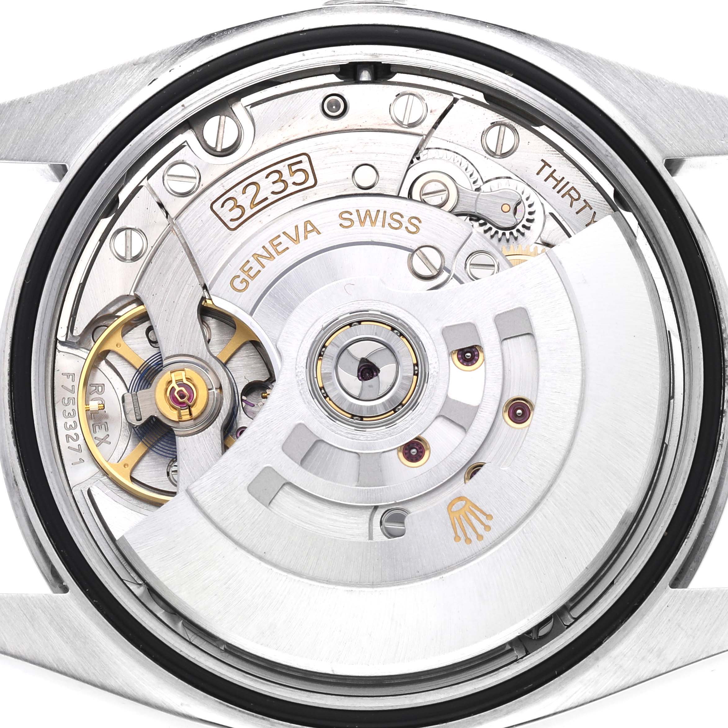 This image shows the movement of a Rolex Datejust 126200 Men's Stainless Steel Black Dial 126200 Men's Stainless Steel Black Dial watch, highlighted by its internal mechanics and the rotor.