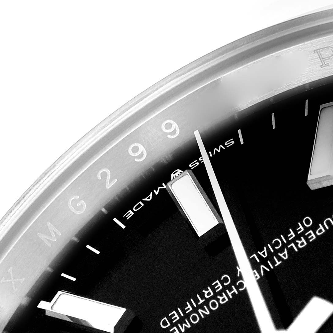 This close-up image of the Rolex Datejust 126200 Men's Stainless Steel Black Dial 126200 Men's Stainless Steel Black Dial shows a portion of the dial with the hour markers and part of the bezel.