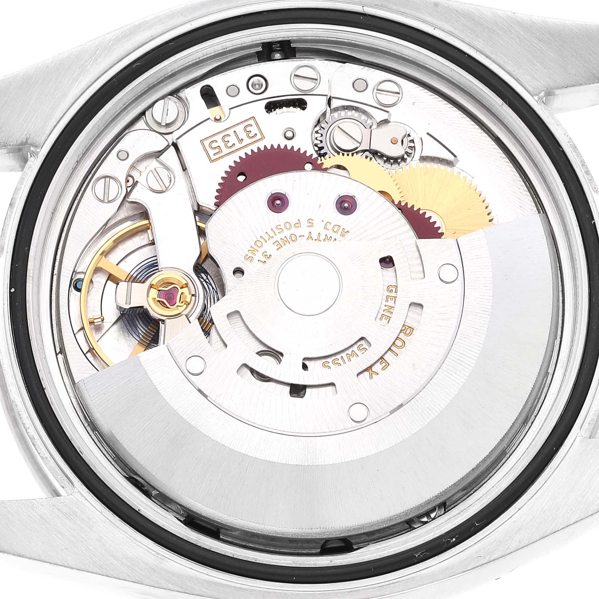 The image shows the back view of the internal mechanism of a Rolex Datejust 116244 Men's Stainless Steel Black Dial 116244 Men's Stainless Steel Black Dial watch, highlighting the movement and gears.