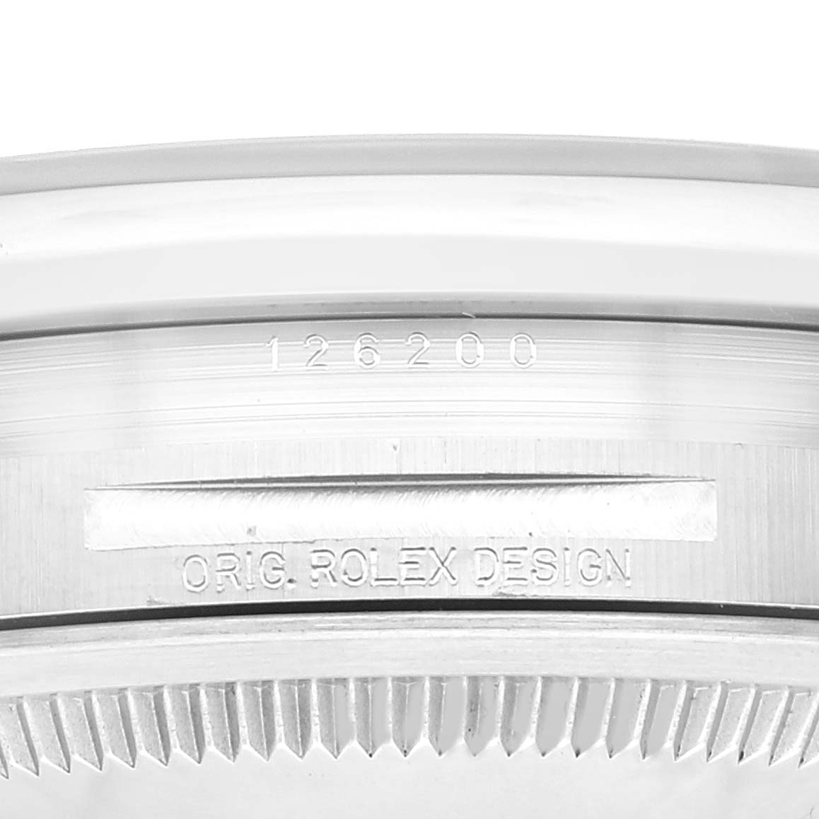 This close-up image of a Rolex Datejust 126200 Men's Stainless Steel Green Dial 126200 Men's Stainless Steel Green Dial watch shows the engraved model number "126200" and the "ORIG. ROLEX DESIGN" on the case.