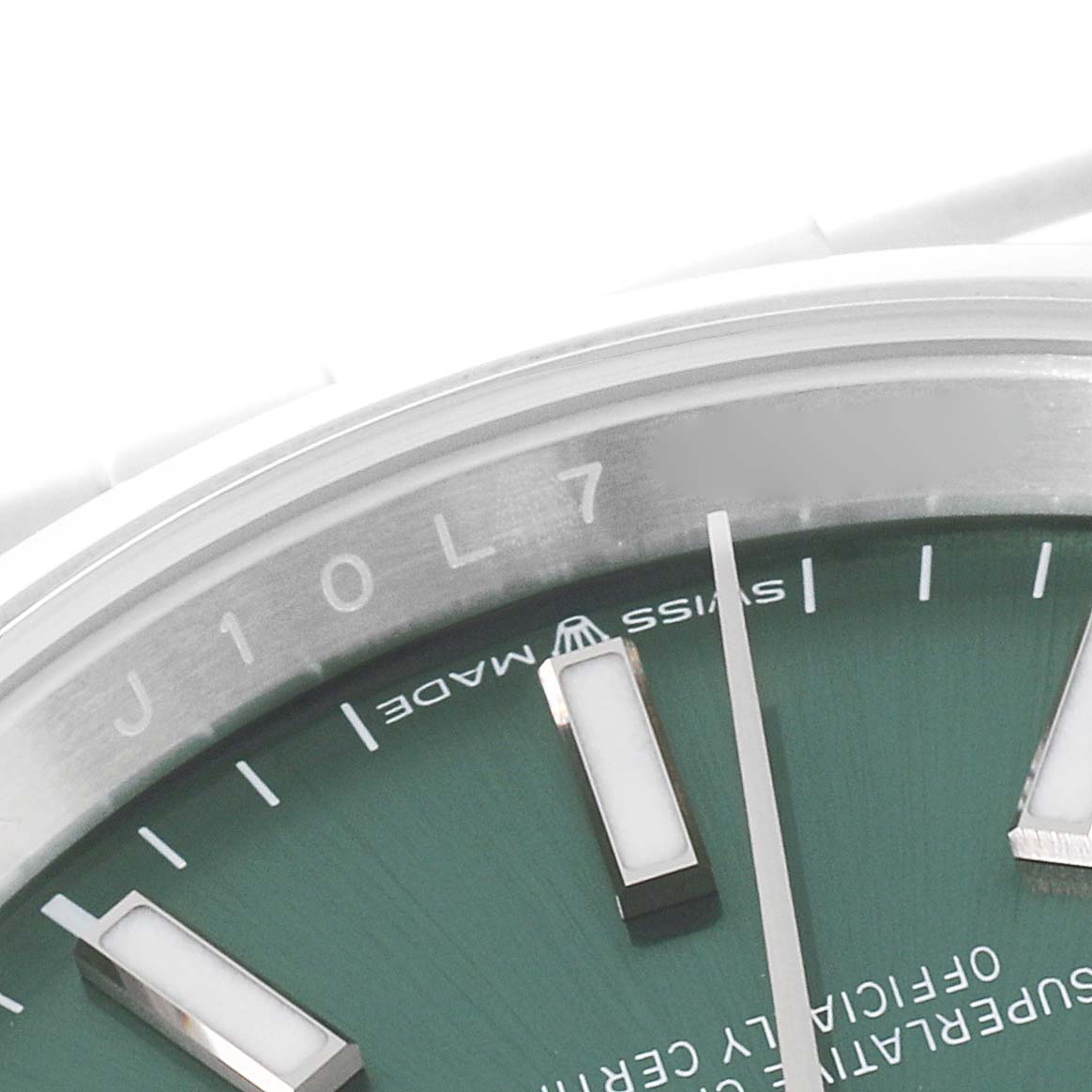 The image shows a close-up of the dial and bezel of the Rolex Datejust 126200 Men's Stainless Steel Green Dial 126200 Men's Stainless Steel Green Dial watch, focusing on registration markings and hour markers.