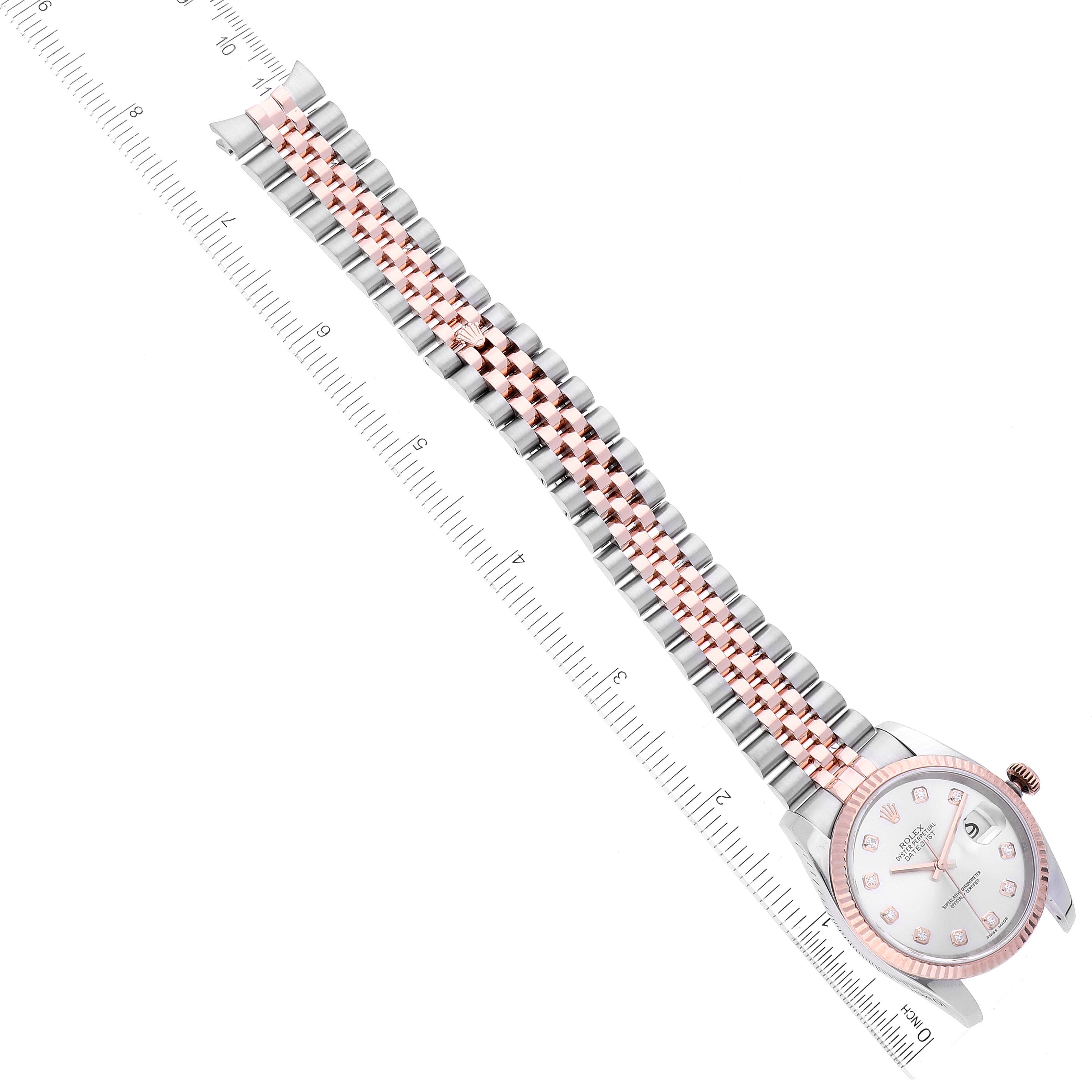 The image shows a Rolex Datejust 116231 Men's Steel and Gold (two tone) Silver Dial 116231 Men's Steel and Gold (two tone) Silver Dial watch from an overhead angle, highlighting its face and two-tone bracelet against a ruler for scale.