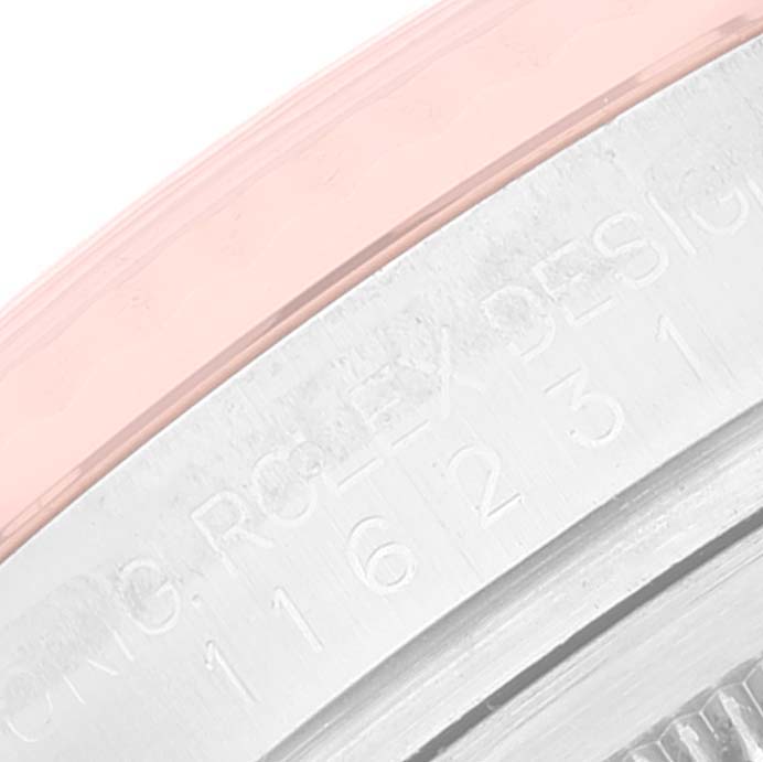 This image shows an angled close-up of the inner rim and engraved details of a Rolex Datejust 116231 Men's Steel and Gold (two tone) Silver Dial 116231 Men's Steel and Gold (two tone) Silver Dial watch.