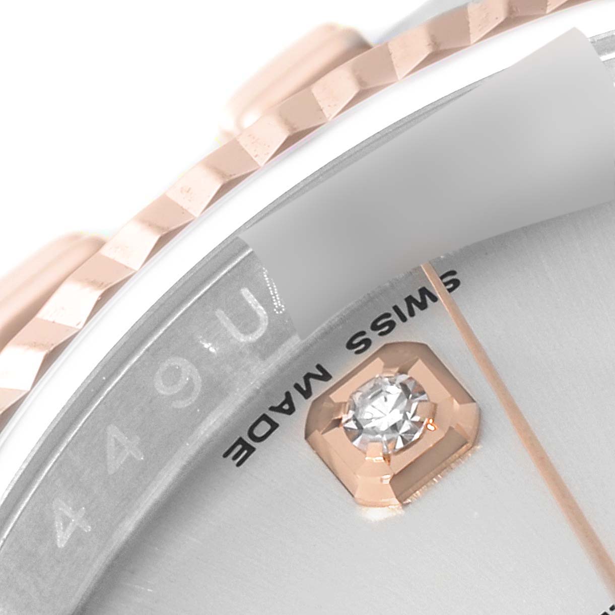 This close-up image of a Rolex Datejust 116231 Men's Steel and Gold (two tone) Silver Dial 116231 Men's Steel and Gold (two tone) Silver Dial watch shows the side of the face, including the bezel, part of the chapter ring, and a diamond hour marker.