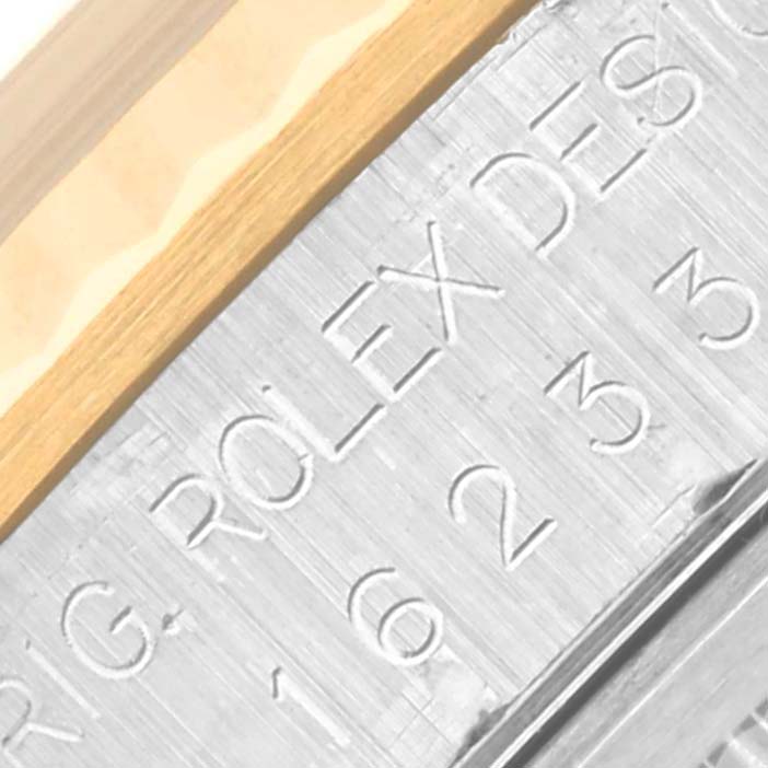 This close-up image of the Rolex Datejust 16233 Men
s Steel and Gold (two tone) Silver Dial 16233 Men
s Steel and Gold (two tone) Silver Dial watch shows part of the case and the engraved branding details.