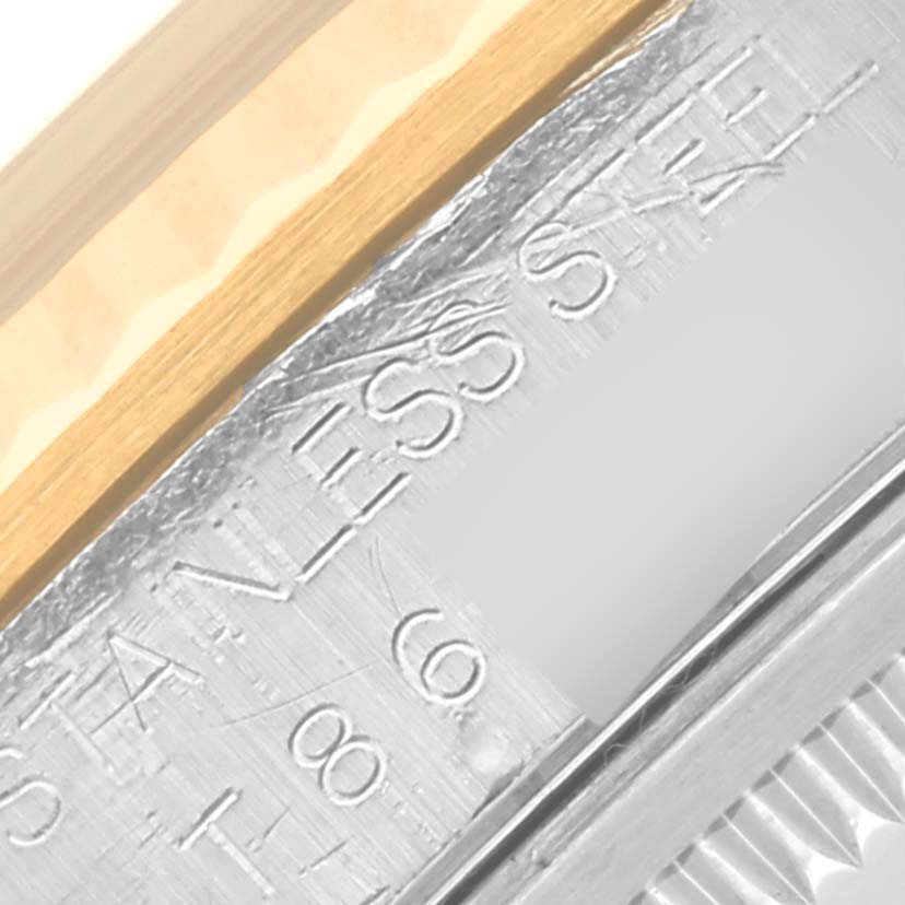 Close-up of the engraved stainless steel inner bezel and the fluted gold bezel of a Rolex Datejust 16233 Men
s Steel and Gold (two tone) Silver Dial 16233 Men
s Steel and Gold (two tone) Silver Dial watch.