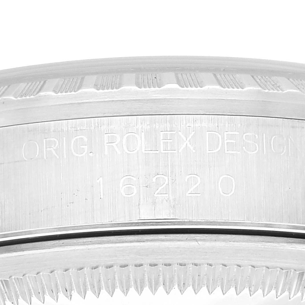 This image shows a close-up of the case side and bezel of the Rolex Datejust 16220 Men's Stainless Steel White Dial 16220 Men's Stainless Steel White Dial model, featuring engraving.