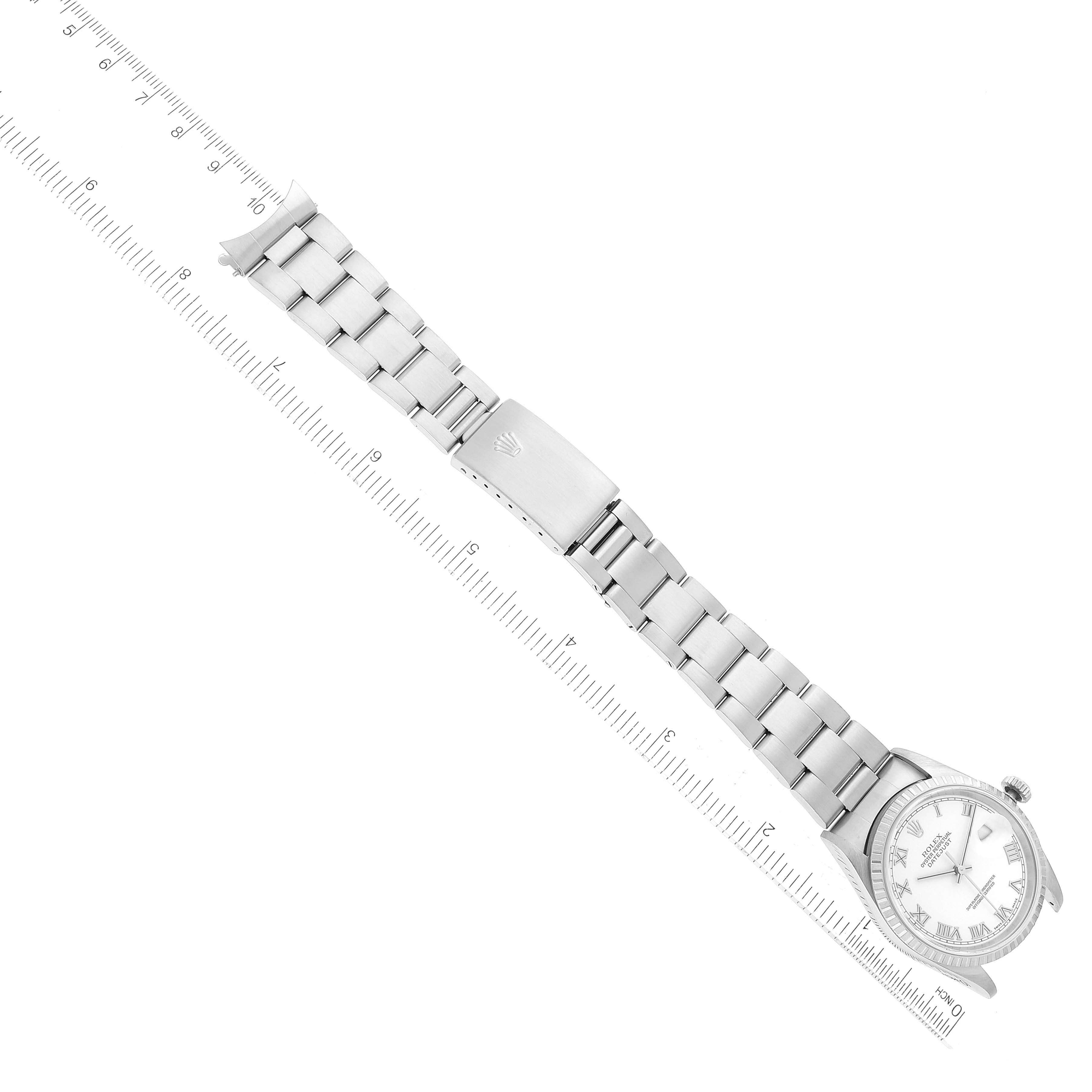 This image shows a Rolex Datejust 16220 Men's Stainless Steel White Dial 16220 Men's Stainless Steel White Dial watch laid flat with a metal bracelet, partially measuring its length with a ruler.