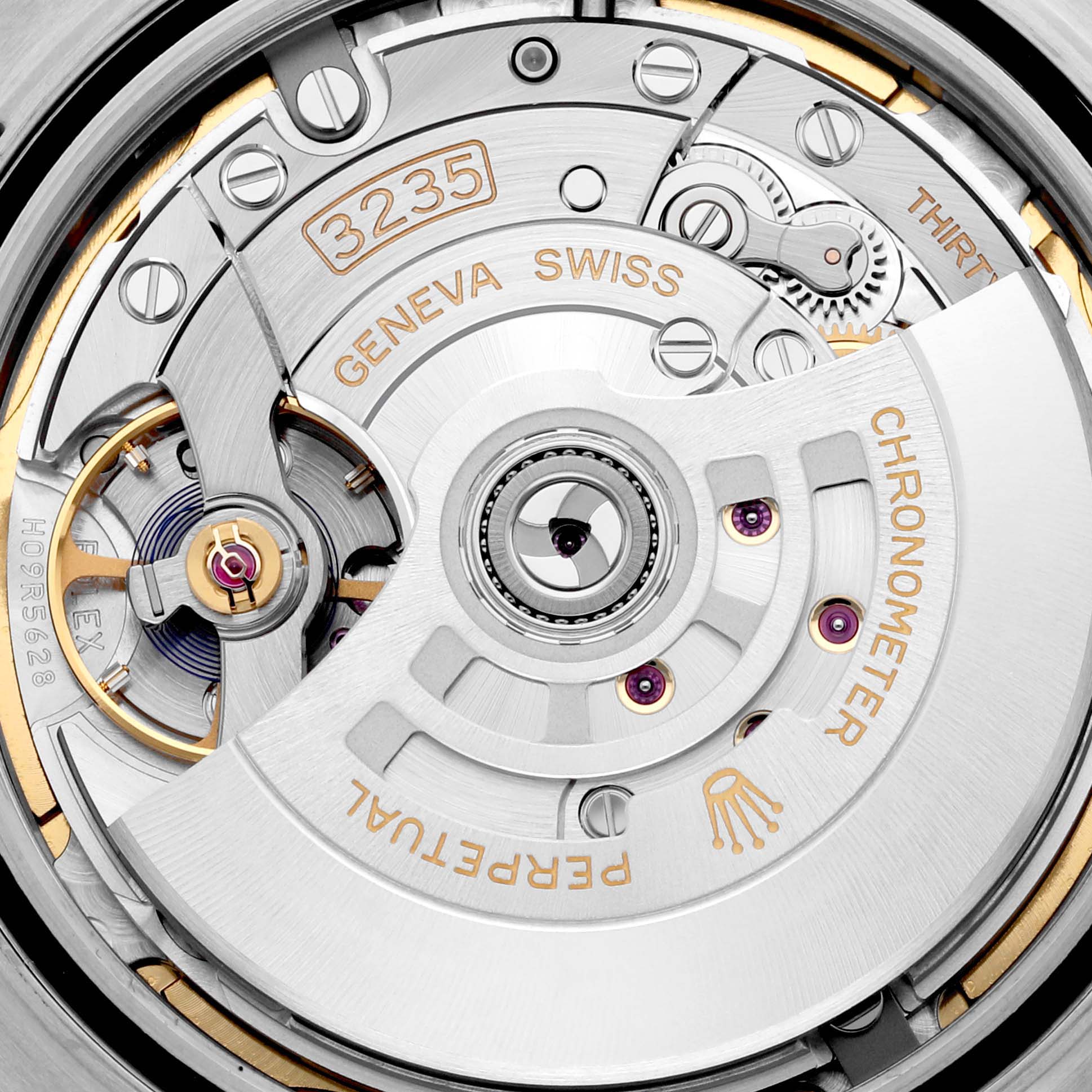 The image shows the movement mechanism of the Rolex Datejust 41 126300 Men's Stainless Steel Green Dial, highlighting intricate components and engravings.