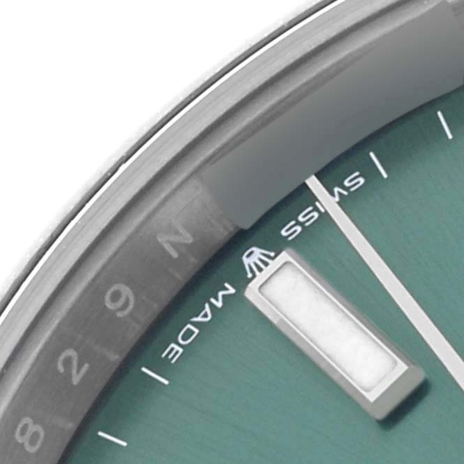 The image shows a close-up of the dial edge and date marker of a Rolex Datejust 41 126300 Men's Stainless Steel Green Dial watch, including the "SWISS MADE" detail.