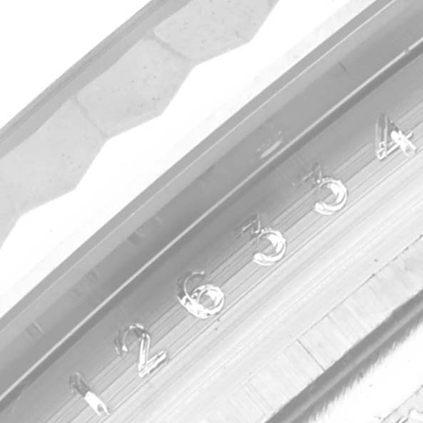 The image shows a close-up view of the Rolex Datejust 41 126334 Men's Stainless Steel White Dial 126334 Men's Stainless Steel White Dial watch's rehaut with engraved numerals and part of the fluted bezel.