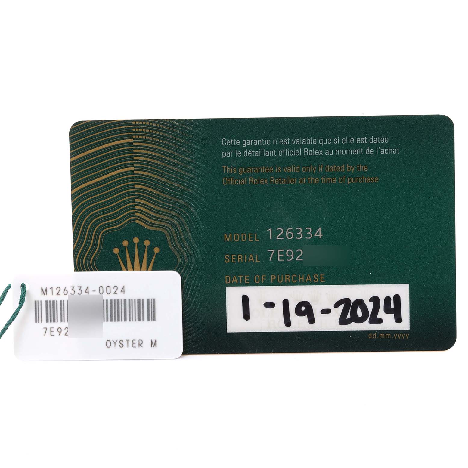 This image shows a guarantee card and tag for a Rolex Datejust 41 126334 Men's Stainless Steel White Dial 126334 Men's Stainless Steel White Dial model, indicating the model number 126334 and the serial number 7E92.