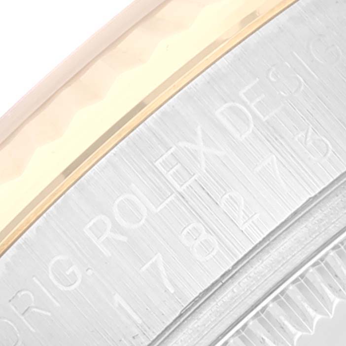 The image shows a close-up of the engraved side of a mid-size Rolex watch.