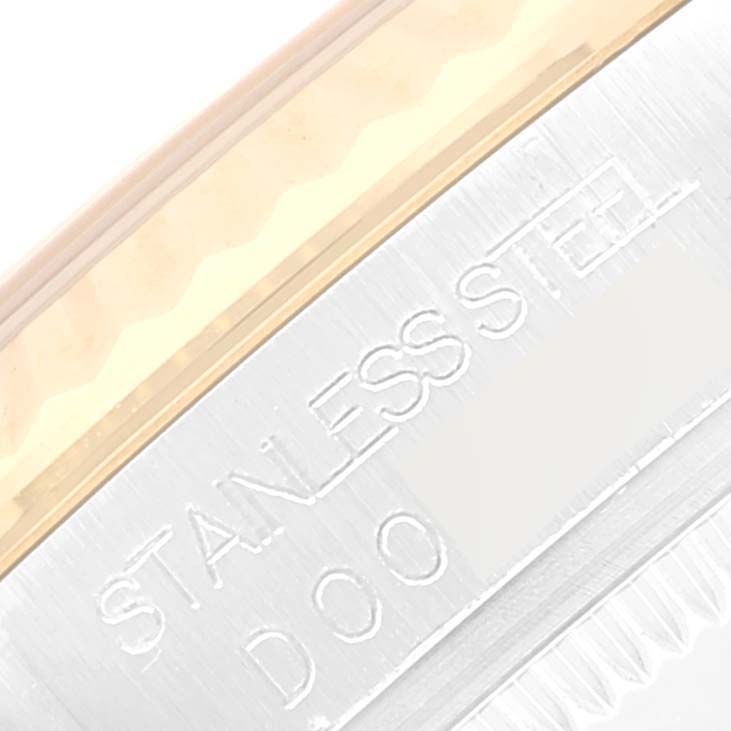 The image shows a close-up of the side of a stainless steel Rolex Mid-Size 178273 Women's Steel and Gold (two tone) Silver Dial 178273 Women's Steel and Gold (two tone) Silver Dial watch, highlighting the engraved "STAINLESS STEEL" text.