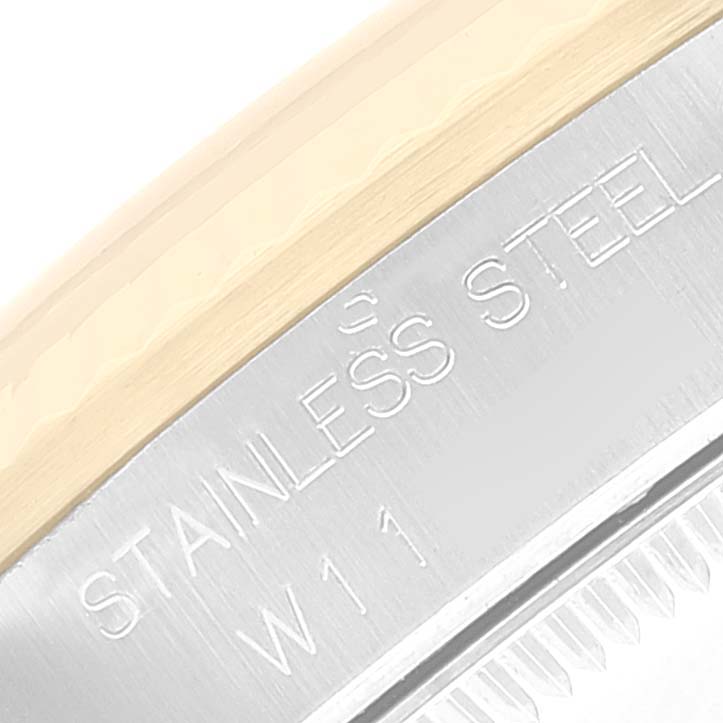 This image shows a close-up of the side edge of a Rolex Mid-Size 68273 Women's Steel and Gold (two tone) Champagne Dial 68273 Women's Steel and Gold (two tone) Champagne Dial watch case, highlighting the "STAINLESS STEEL" engraving and model number "W11".
