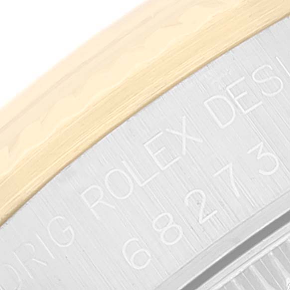 The image shows a close-up of the back case of a Mid-Size Rolex watch, displaying the engraved text on its metal surface.