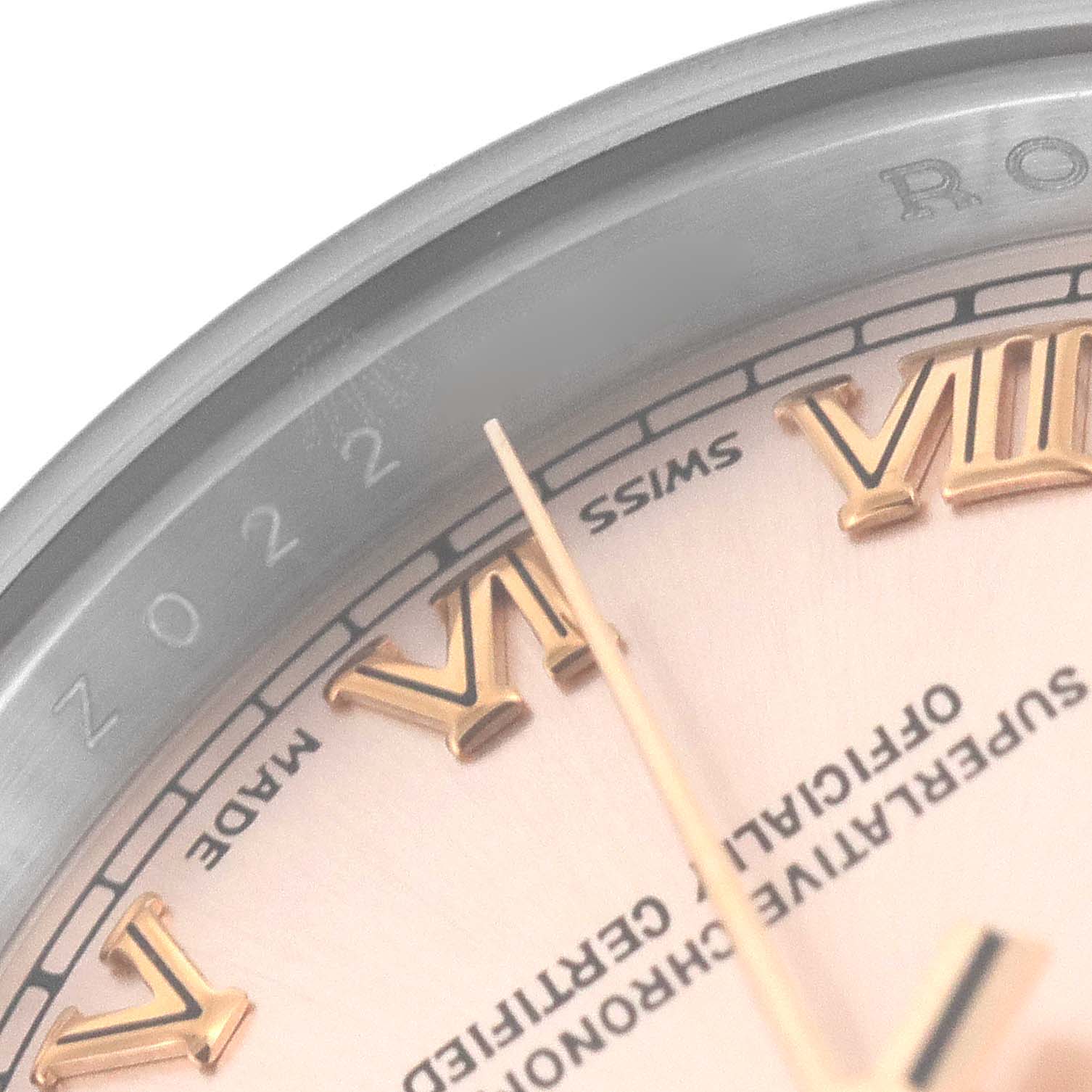 This image shows a close-up of the dial and bezel of a Rolex Datejust 179161 Women's Steel and Gold (two tone) Pink Dial 179161 Women's Steel and Gold (two tone) Pink Dial watch, focusing on the Roman numerals and text details.