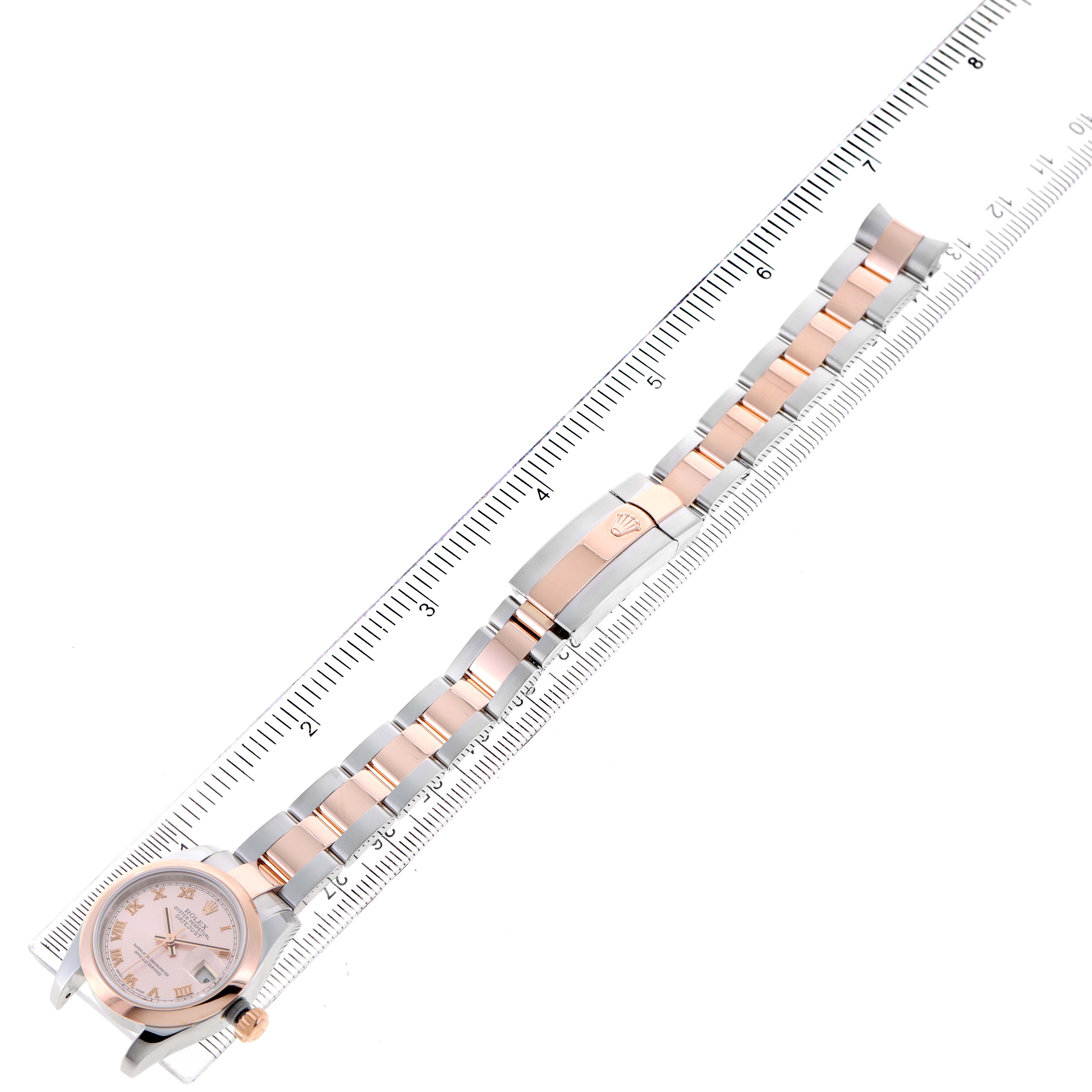 The image shows a top view of the Rolex Datejust 179161 Women's Steel and Gold (two tone) Pink Dial 179161 Women's Steel and Gold (two tone) Pink Dial watch, focusing on its face, bracelet, and deployment clasp, with a ruler for scale.