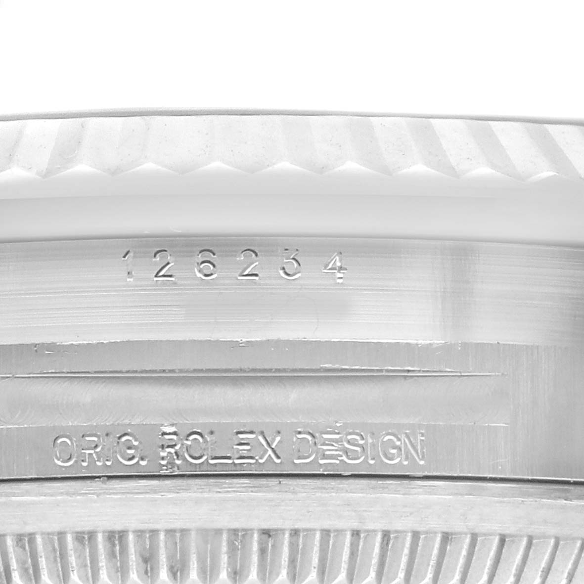 Close-up of the side of a Rolex Datejust 126234 Men
s Stainless Steel Green Dial 126234 Men
s Stainless Steel Green Dial watch, showing the model number and the "ORIG. ROLEX DESIGN" engraving.