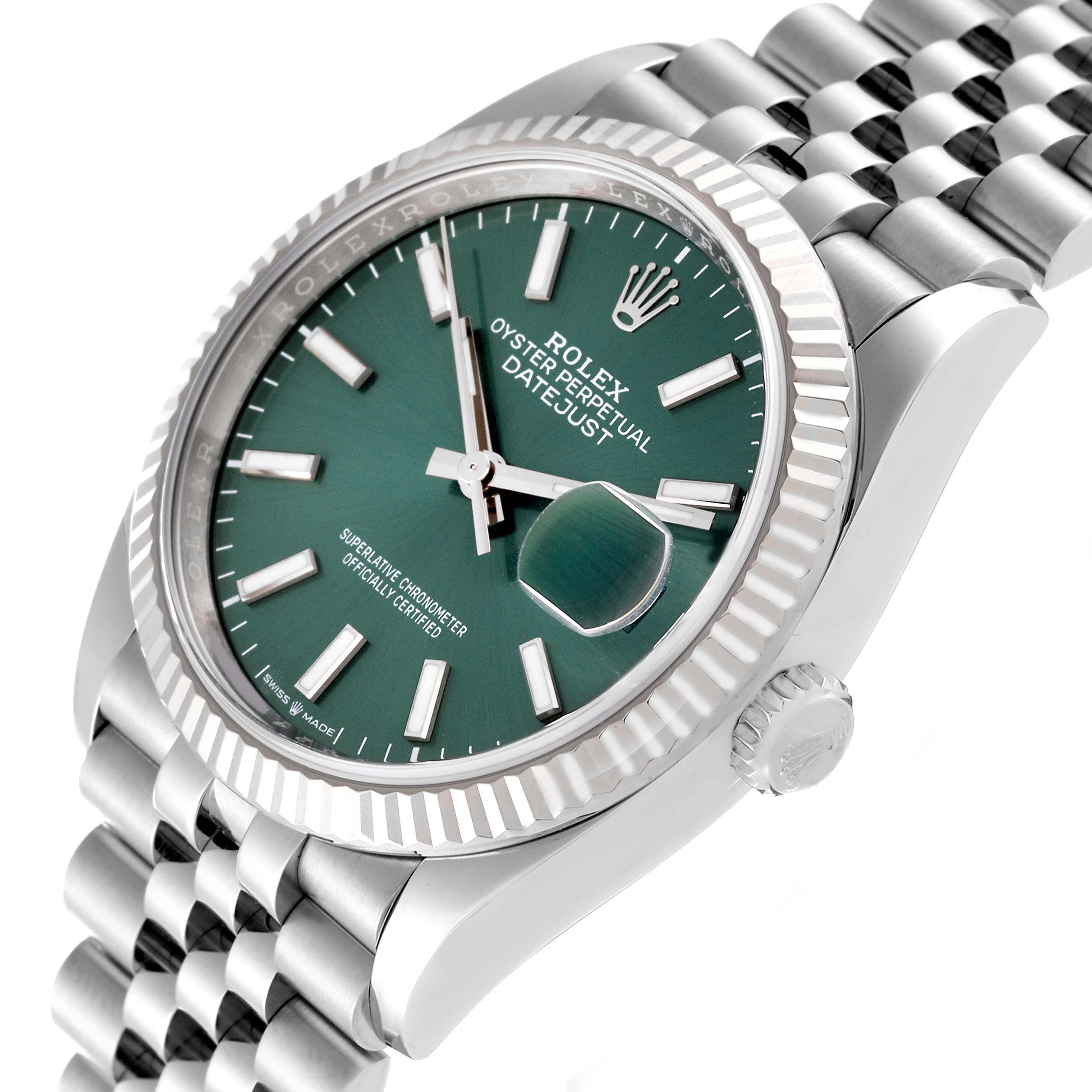 This image shows a close-up, angled view of a Rolex Datejust 126234 Men
s Stainless Steel Green Dial 126234 Men
s Stainless Steel Green Dial watch, featuring the green dial, fluted bezel, and part of the bracelet.