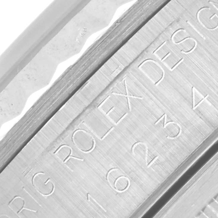 This image shows a close-up of the engraved inner bezel and case edge of a Rolex Datejust 16234 Men's Stainless Steel White Dial 16234 Men's Stainless Steel White Dial watch.