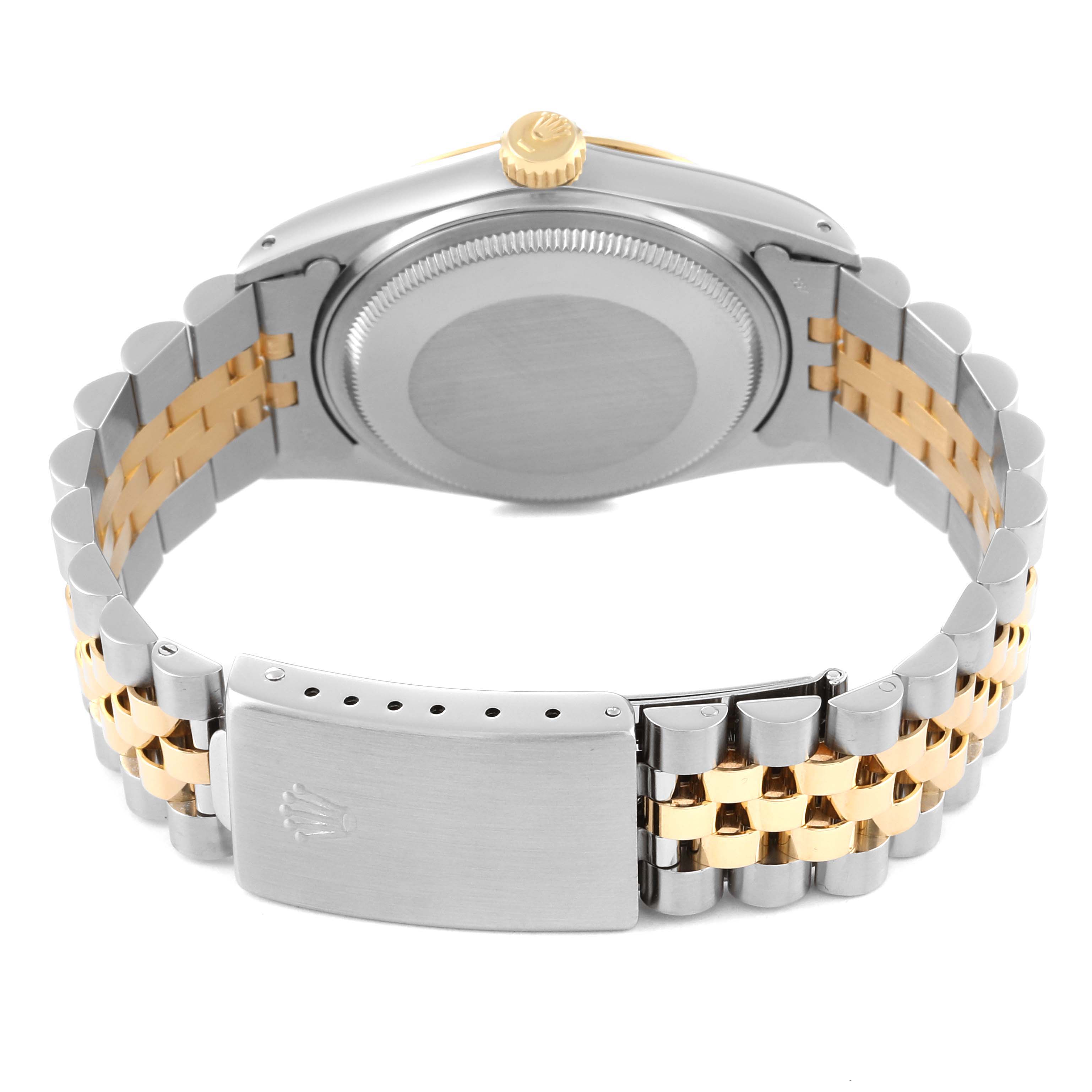 This image shows the backside of a Rolex Datejust 16013 Men's Steel and Gold (two tone) Champagne Dial 16013 Men's Steel and Gold (two tone) Champagne Dial watch with a view of the case, crown, and Jubilee bracelet clasp.