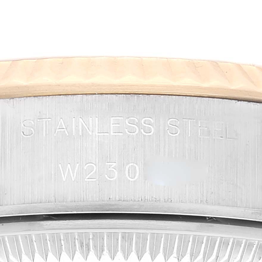 This close-up image shows the side engraving and part of the bezel of a Rolex Datejust 69173 Women's Steel and Gold (two tone) Champagne Dial 69173 Women's Steel and Gold (two tone) Champagne Dial watch.