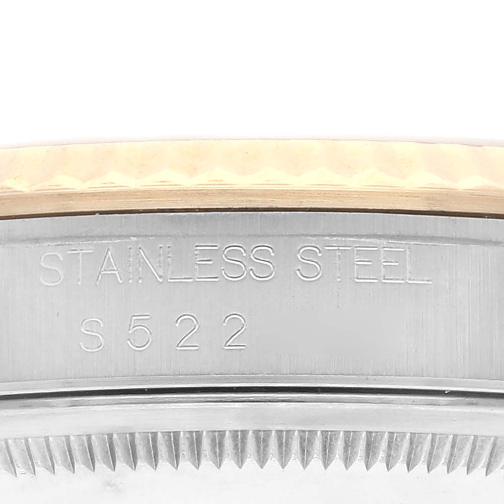 This image shows a close-up of the stainless steel part and bezel of the Rolex Datejust 16233 Men's Steel and Gold (two tone) Champagne Dial 16233 Men's Steel and Gold (two tone) Champagne Dial watch, displaying the "STAINLESS STEEL S 522" engraving.