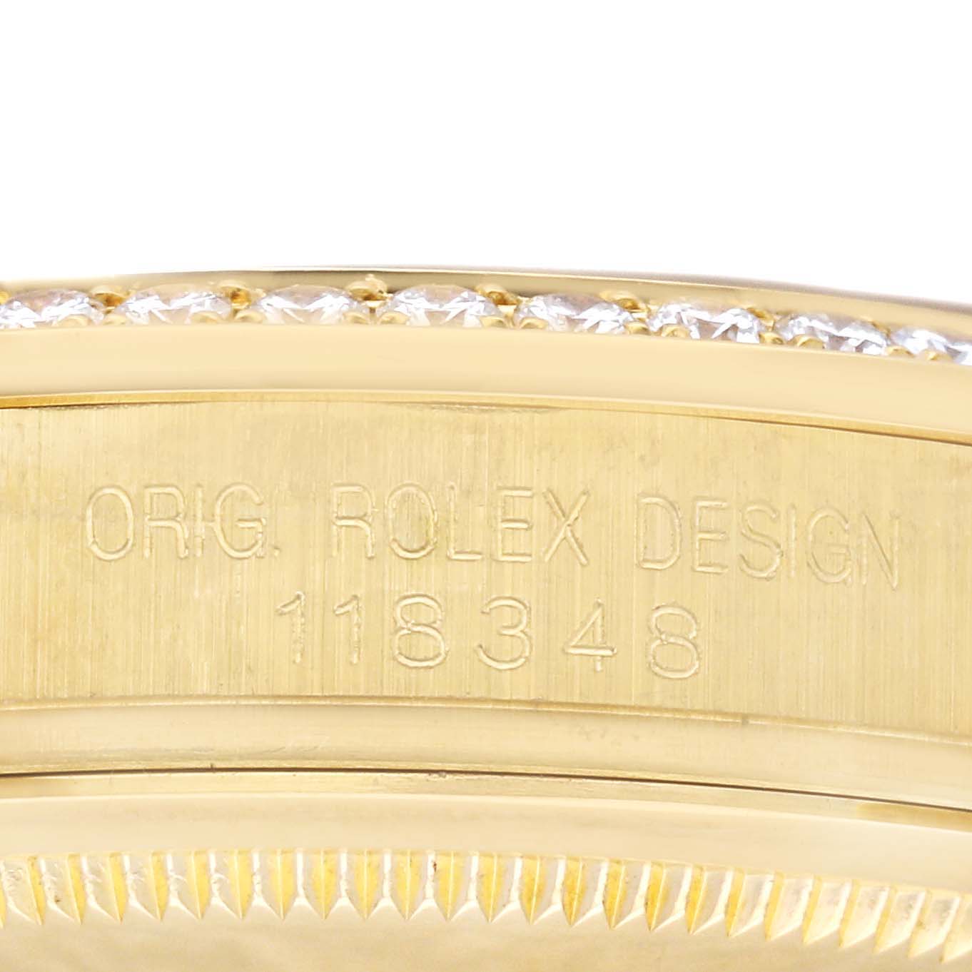 This close-up image shows the side of a Rolex President 118348 Men
s Yellow Gold Champagne Dial 118348 Men
s Yellow Gold Champagne Dial model watch with engraved details and part of the diamond bezel.