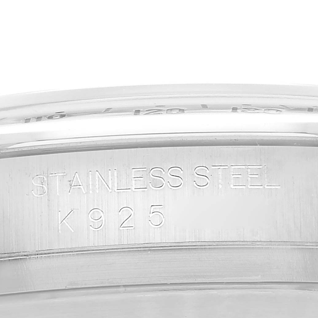 This image shows a close-up of the case back and edge of a Rolex Daytona 116520 Men
s Stainless Steel White Dial 116520 Men
s Stainless Steel White Dial watch, highlighting the engraved marking "STAINLESS STEEL K925."