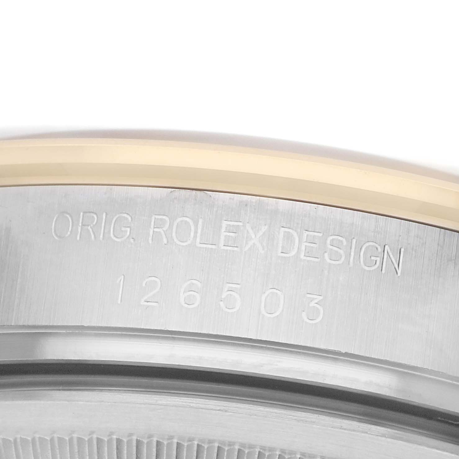 The image shows a close-up of the edge of a Rolex Daytona 126503 Men's Steel and Gold (two tone) Champagne Dial watch case with the model number "126503" engraved.